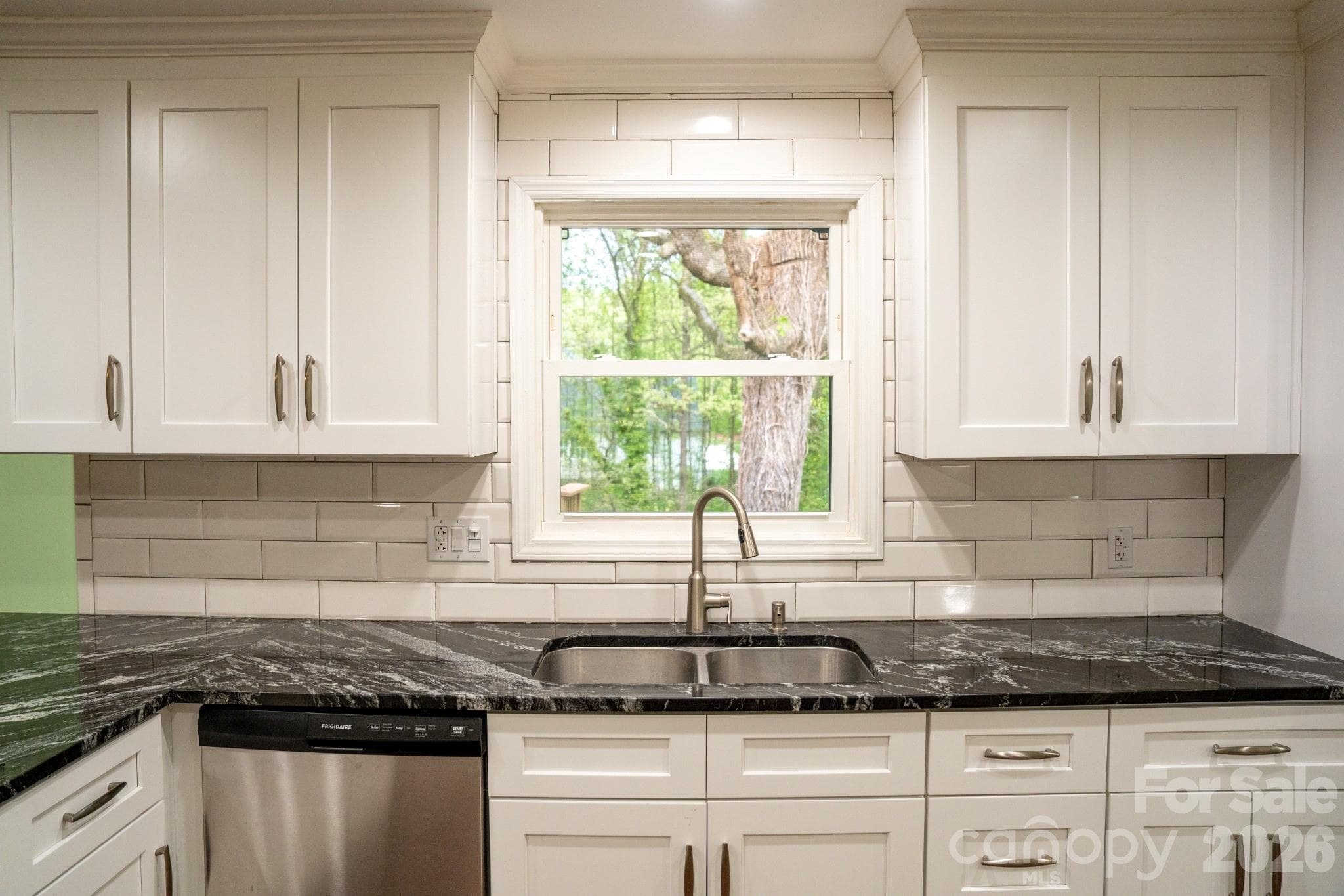 Stainless steel sink with gooseneck faucet, wash your dishes overlooking the fenced back yard - Statesville