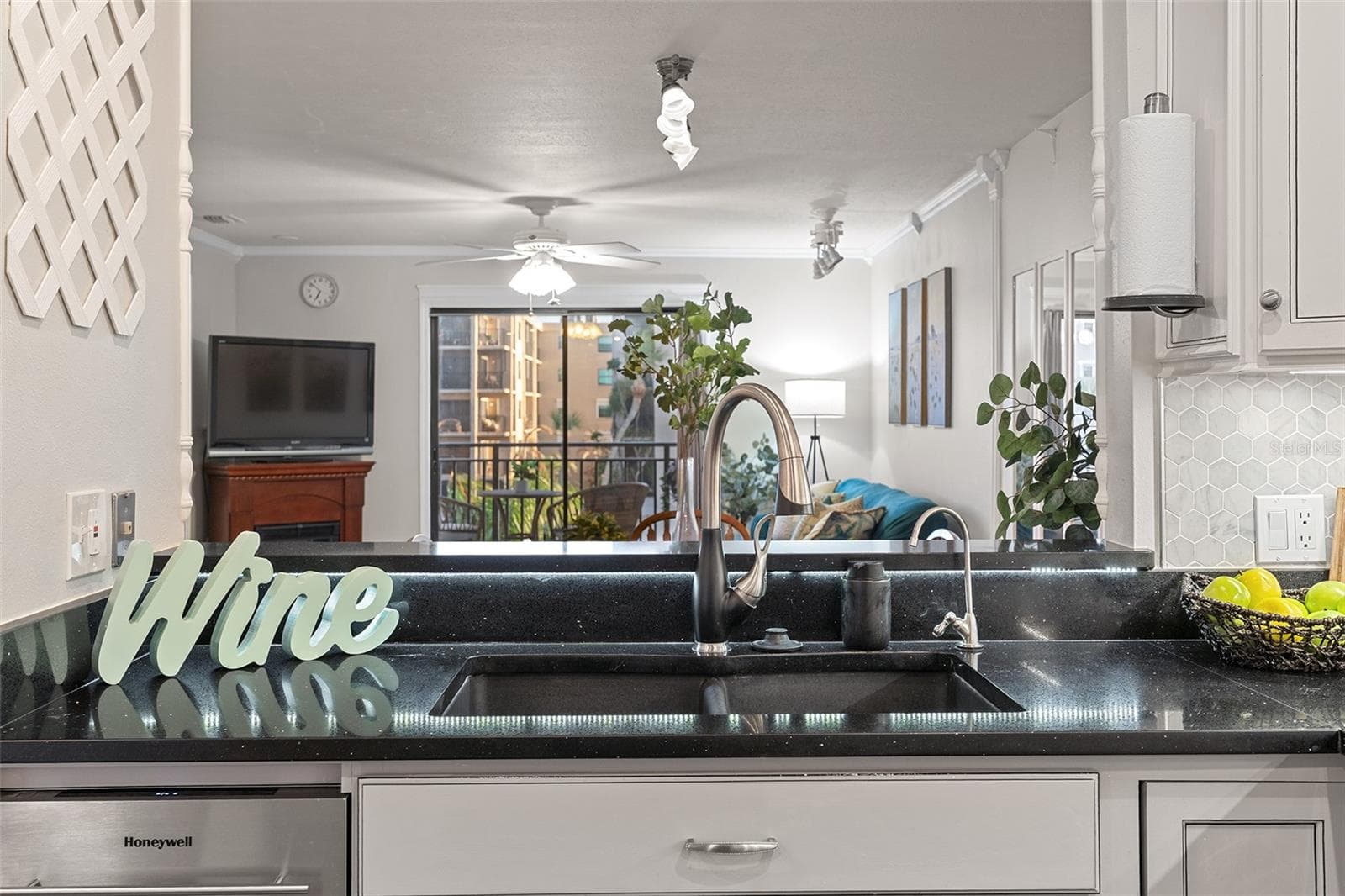 Kitchen sink overlooks living area - 200 INTERNATIONAL DRIVE #815, CAPE CANAVERAL