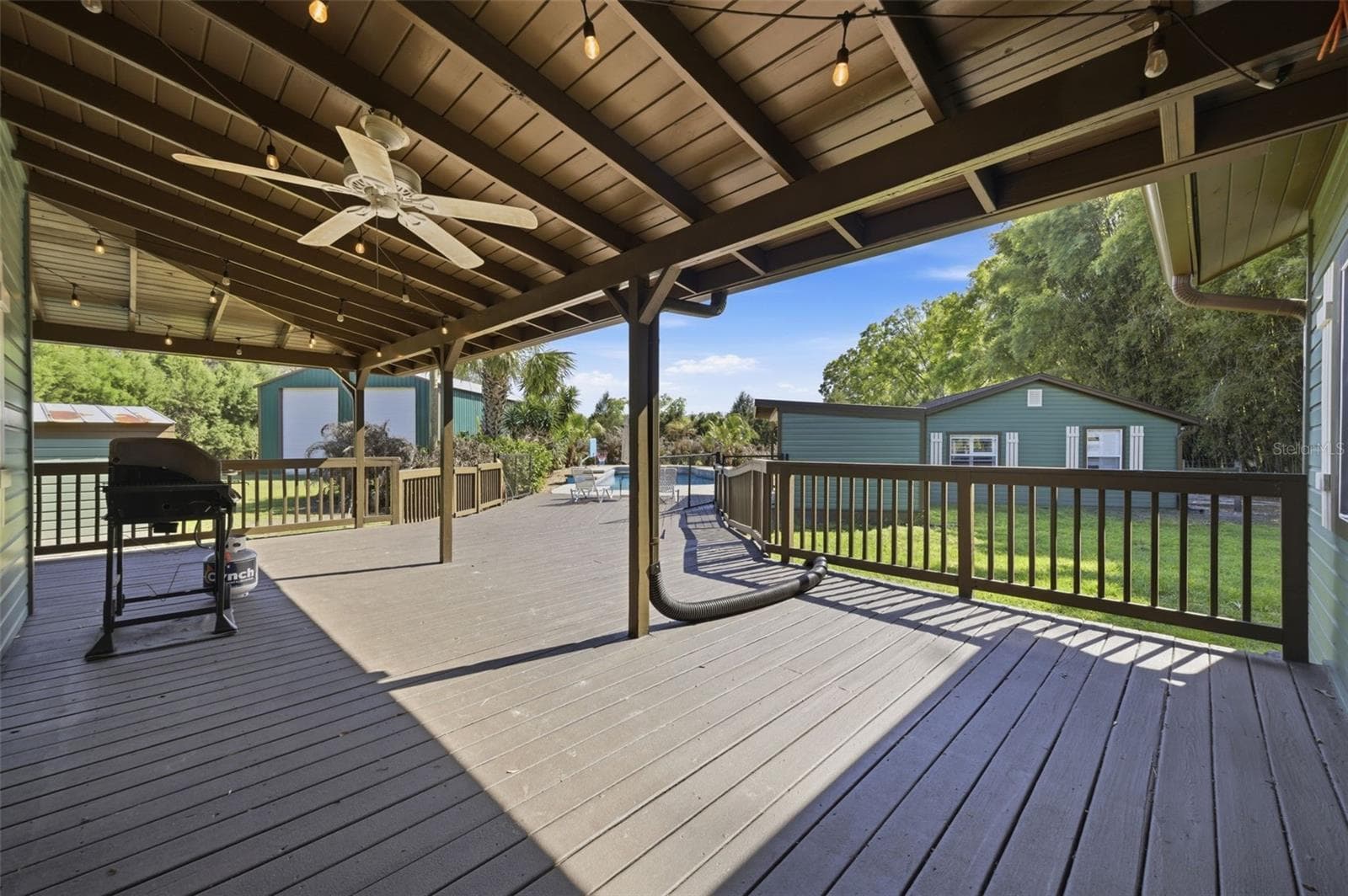 back porch headed toward pool and In law suite - 3752 OLD KEYSTONE RD, TARPON SPRINGS