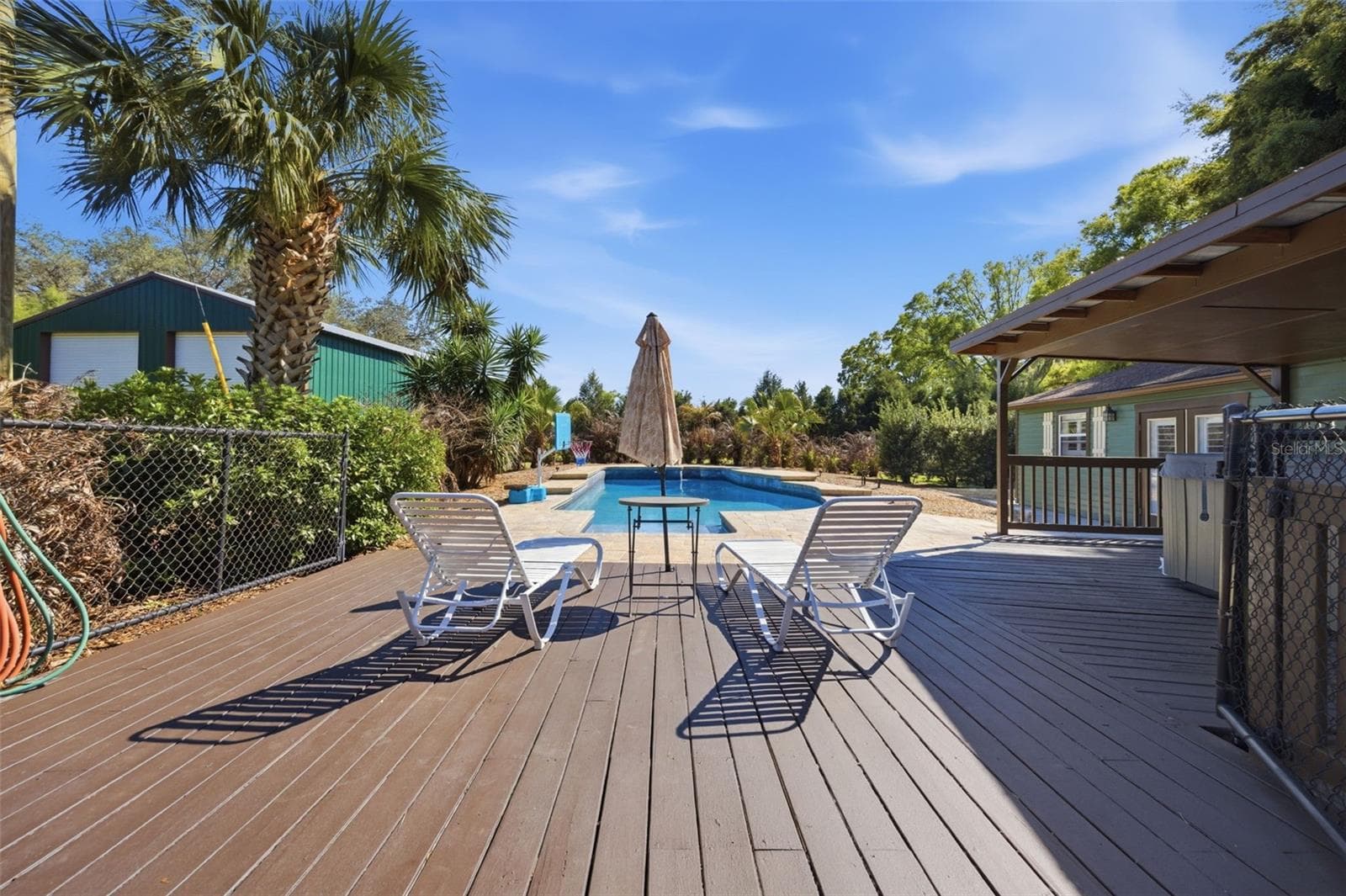 Deck with hot tub to right and view of gorgeous pool - 3752 OLD KEYSTONE RD, TARPON SPRINGS