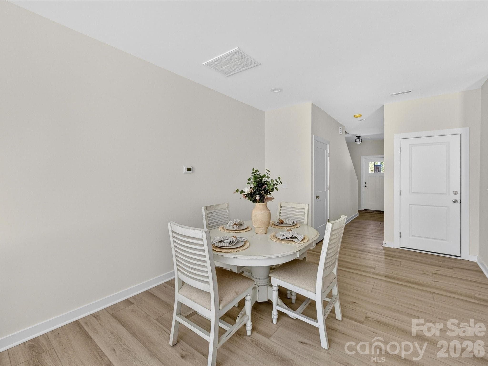 Open-concept kitchen flows seamlessly into a bright breakfast nook and living area, creating an inviting space ideal for both everyday dining and entertaining. - 655 Stillgreen Lane, Charlotte