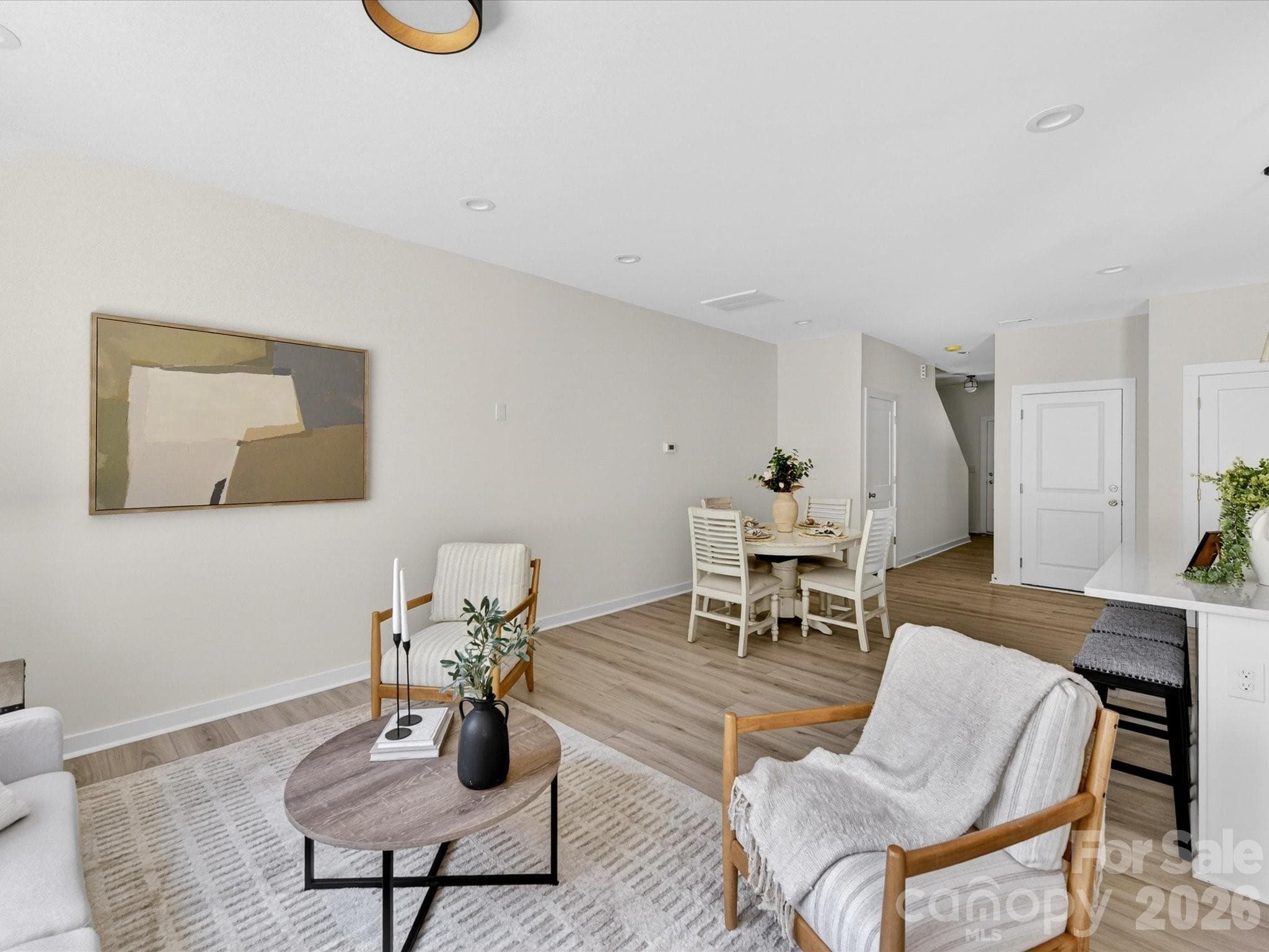 Bright and inviting family room filled with natural light, offering an open layout that seamlessly connects to the kitchen and dining area for comfortable everyday living. - 655 Stillgreen Lane, Charlotte