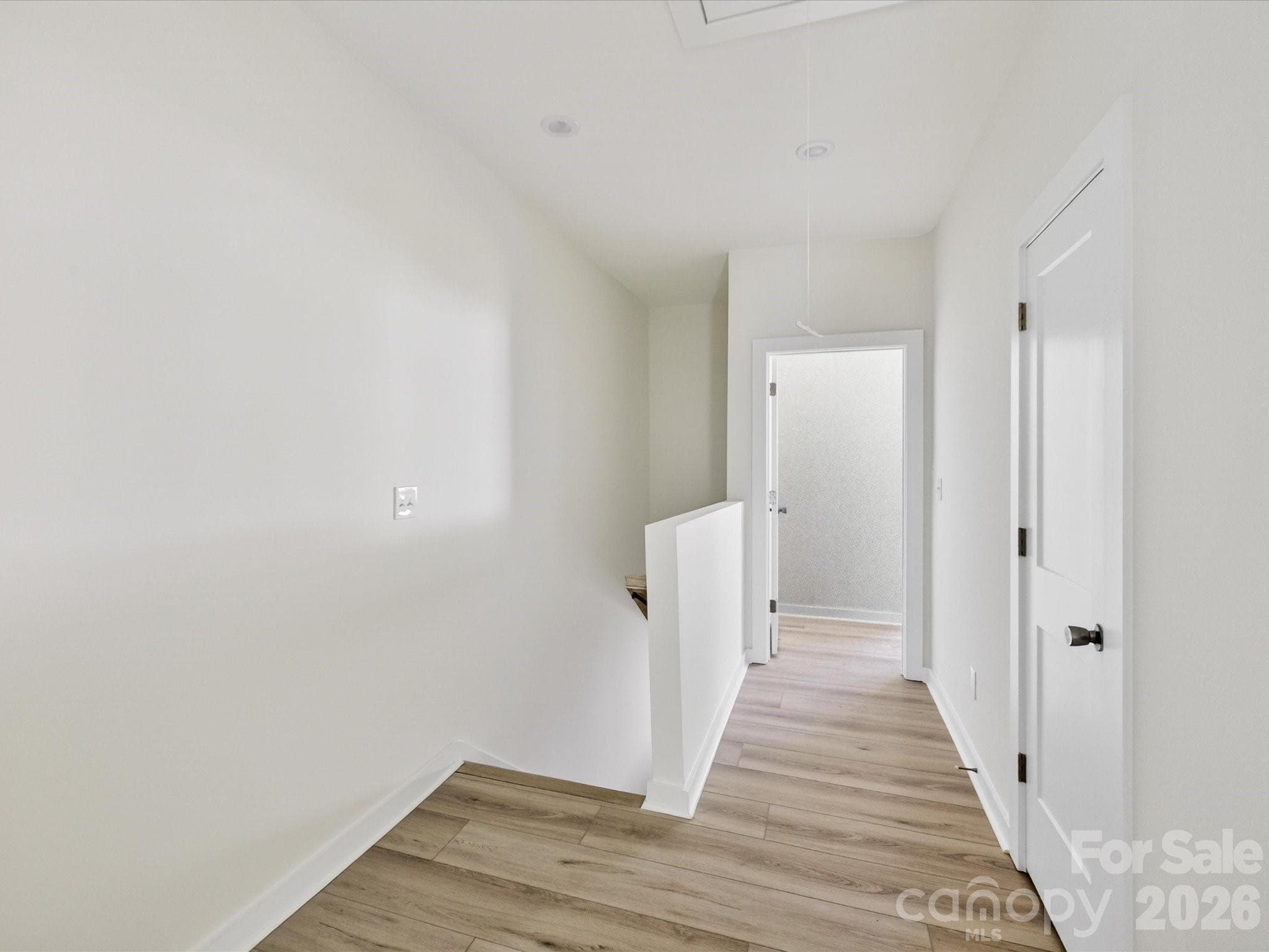 Spacious upper-level landing with clean finishes and versatile space ideal for a small workspace, reading nook, or added functionality. - 655 Stillgreen Lane, Charlotte