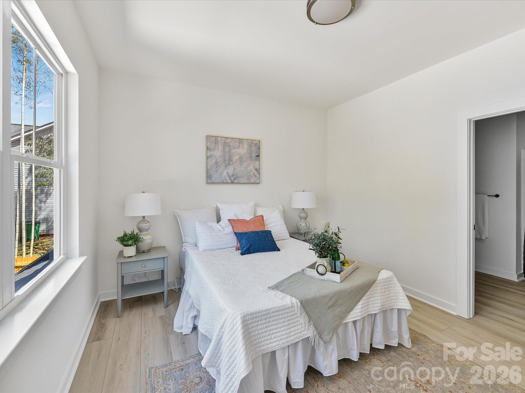 Spacious and light-filled primary suite featuring large windows, neutral finishes, and a comfortable layout perfect for rest and relaxation. - 655 Stillgreen Lane, Charlotte