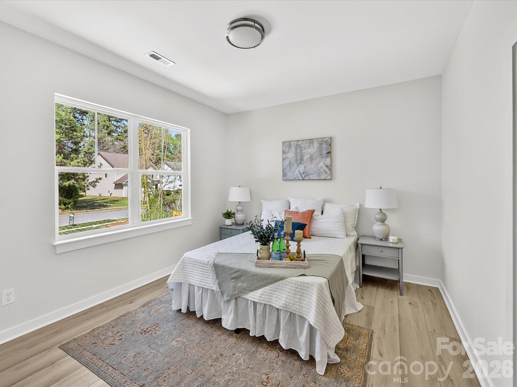 Spacious and light-filled primary suite featuring large windows, neutral finishes, and a comfortable layout perfect for rest and relaxation. - 655 Stillgreen Lane, Charlotte