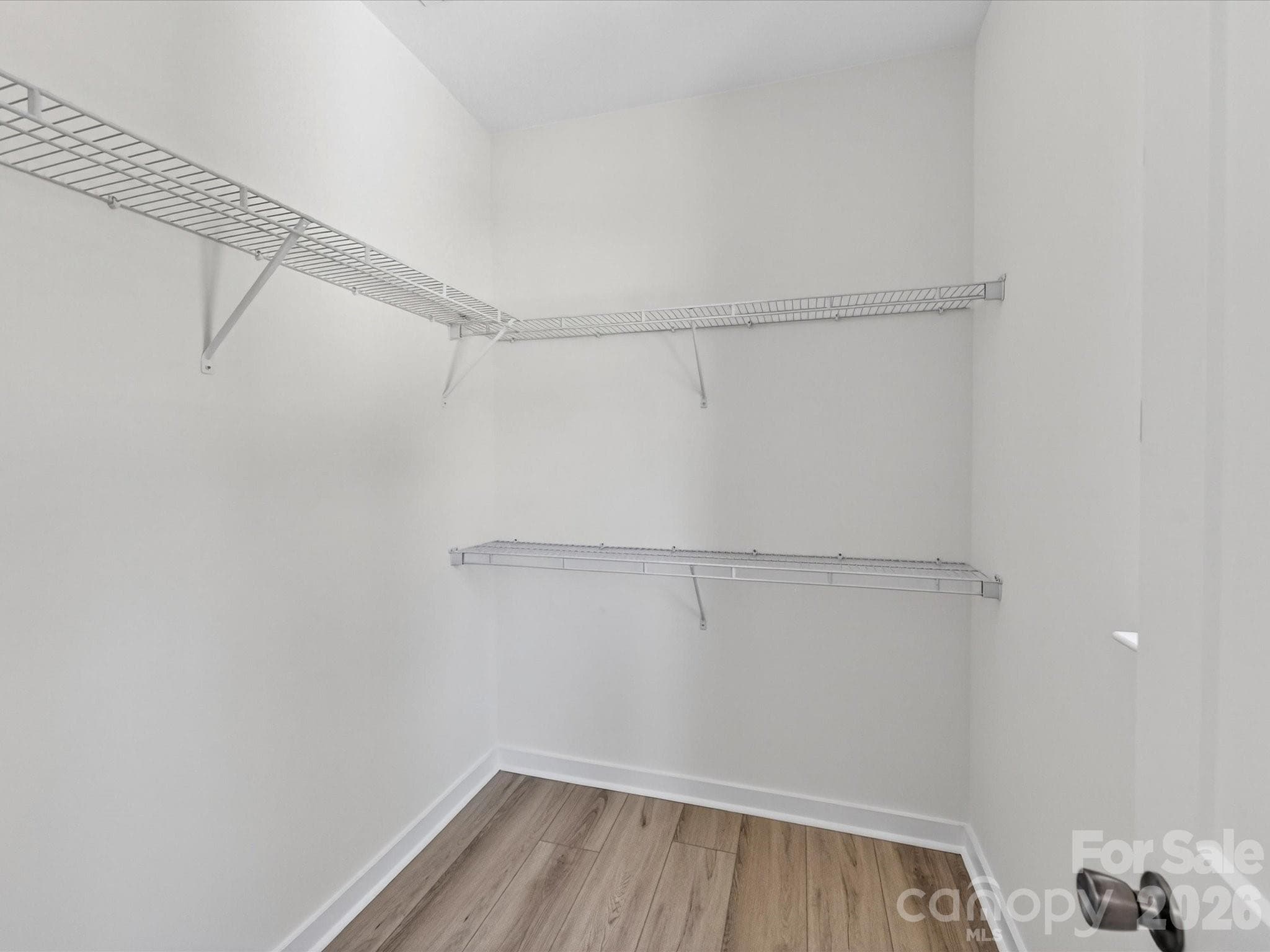 Ample space in the walk-in closet with ample shelving and storage options to keep your wardrobe organized. - 655 Stillgreen Lane, Charlotte