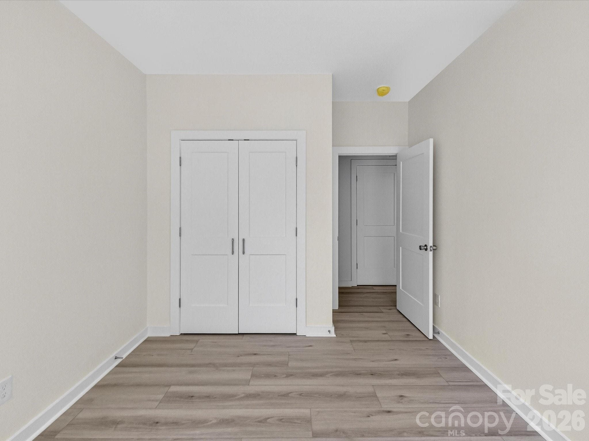 Bright secondary bedroom featuring abundant natural light, neutral finishes, and a versatile layout perfect for guests, family, or a home office. - 655 Stillgreen Lane, Charlotte