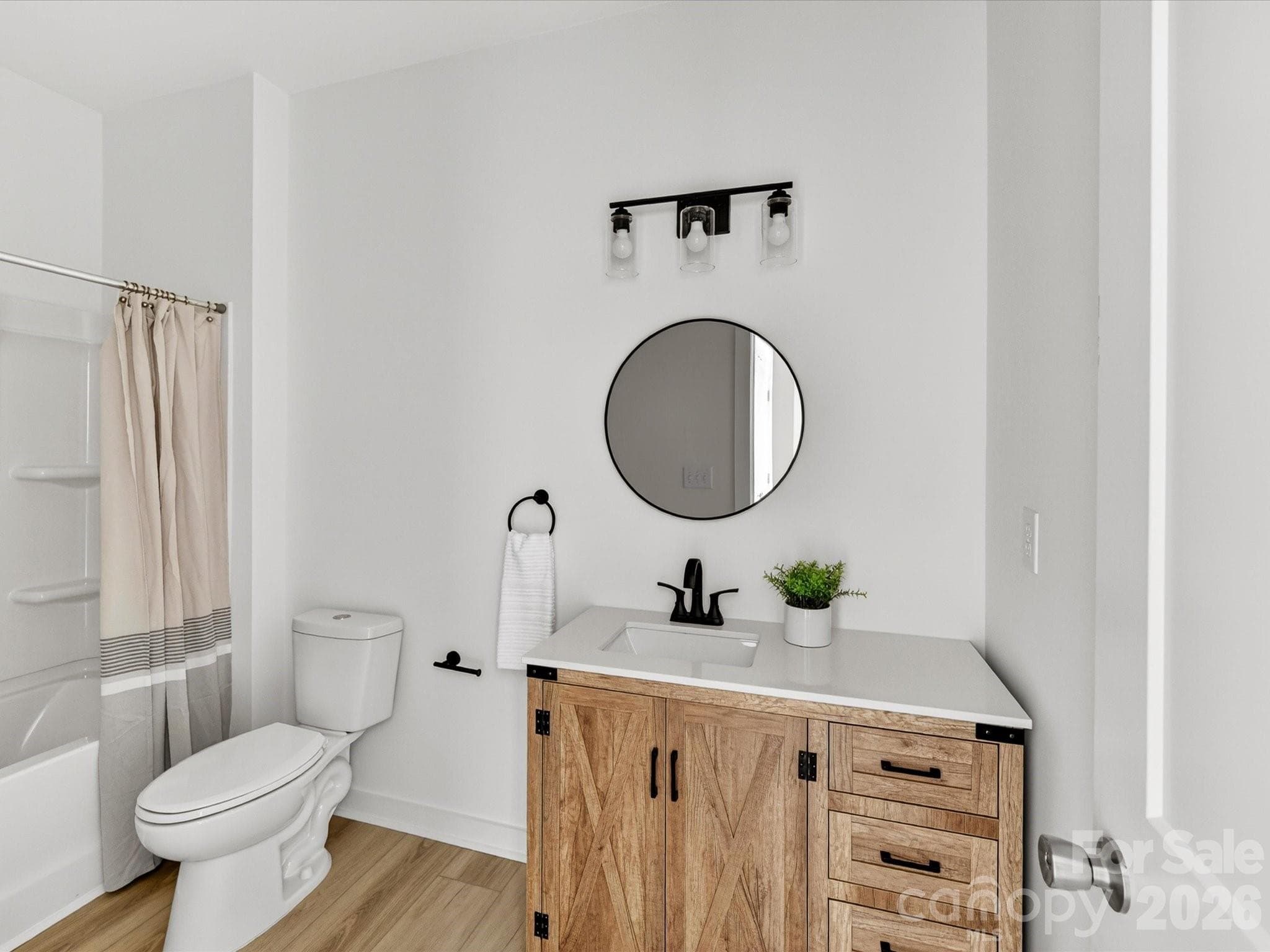 Full bathroom featuring a stylish vanity with ample storage, modern fixtures, and a tub/shower combination for everyday convenience. - 655 Stillgreen Lane, Charlotte