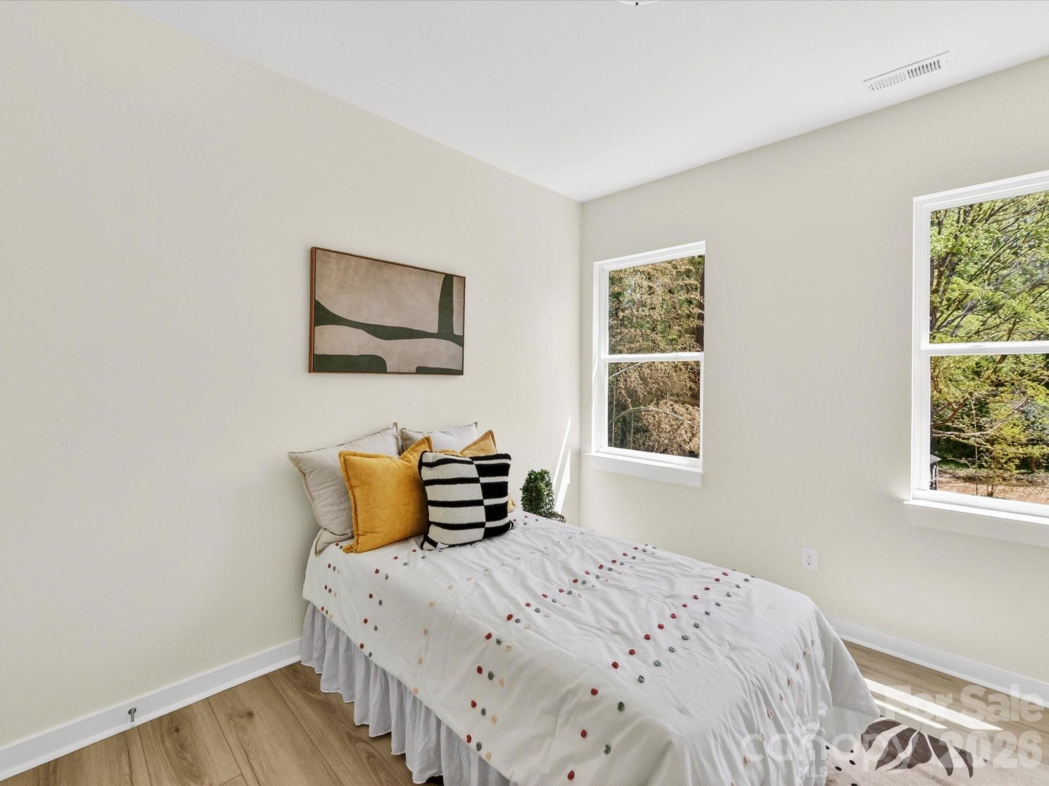 Cozy secondary bedroom filled with natural light, featuring neutral tones and a flexible layout ideal for guests, a home office, or additional living space. - 655 Stillgreen Lane, Charlotte