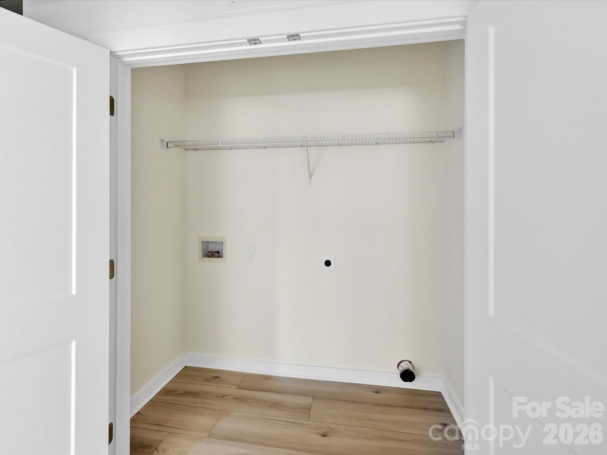 Dedicated laundry area with convenient washer and dryer hookups and built-in shelving for added storage. - 655 Stillgreen Lane, Charlotte
