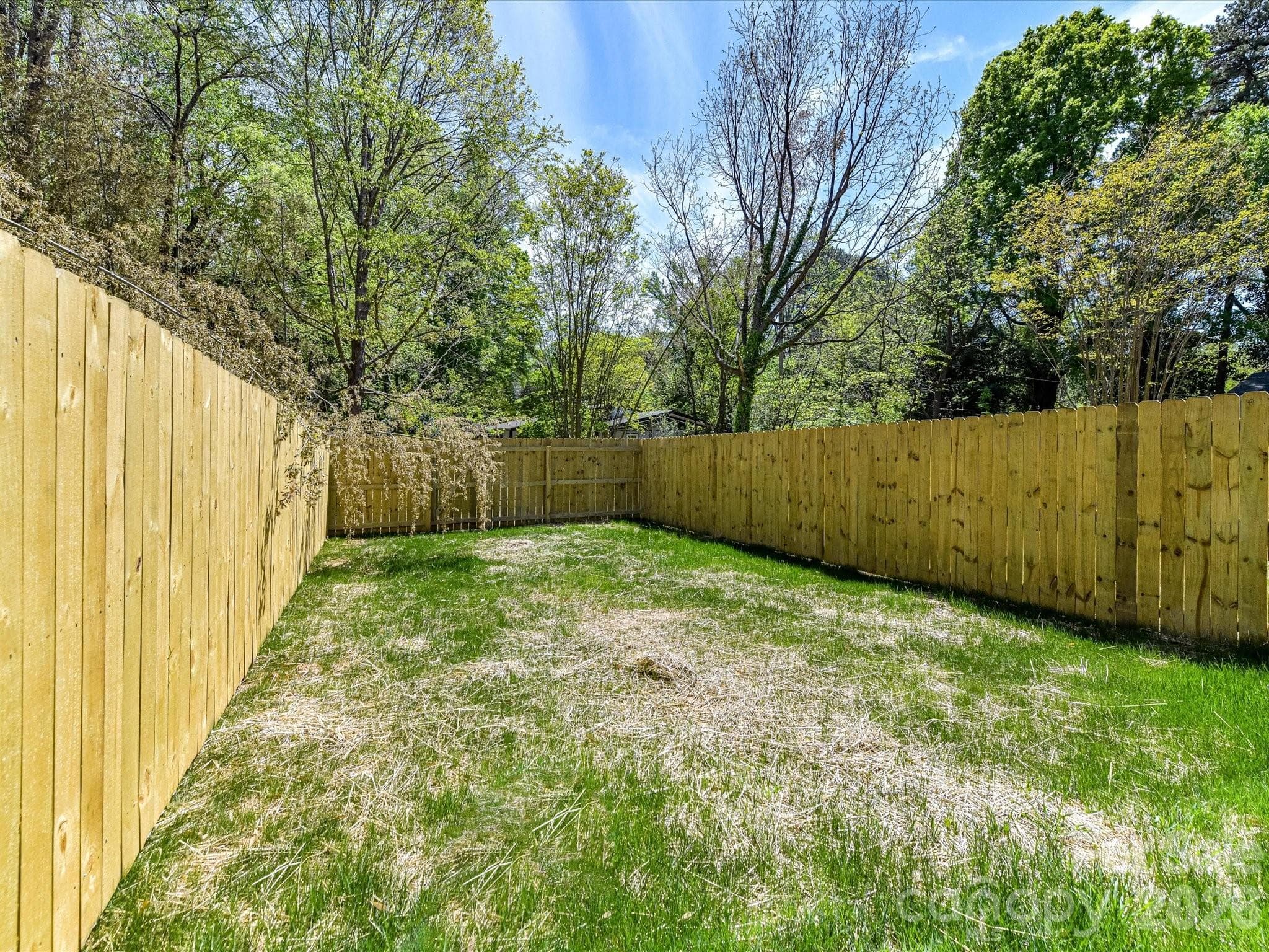 Sizeable fenced backyard offering privacy and plenty of room for outdoor entertaining, pets, or play. - 655 Stillgreen Lane, Charlotte