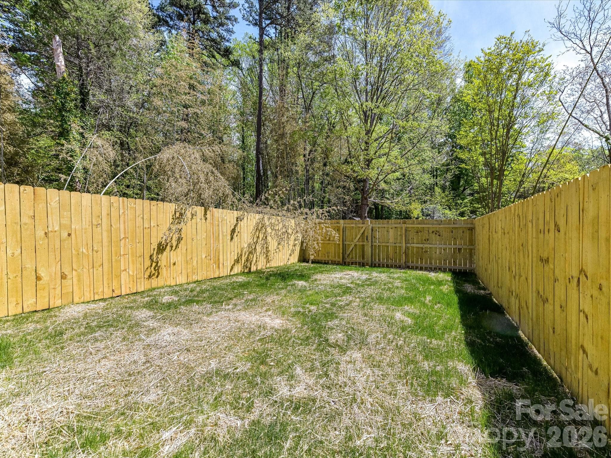 Sizeable fenced backyard offering privacy and plenty of room for outdoor entertaining, pets, or play. - 655 Stillgreen Lane, Charlotte