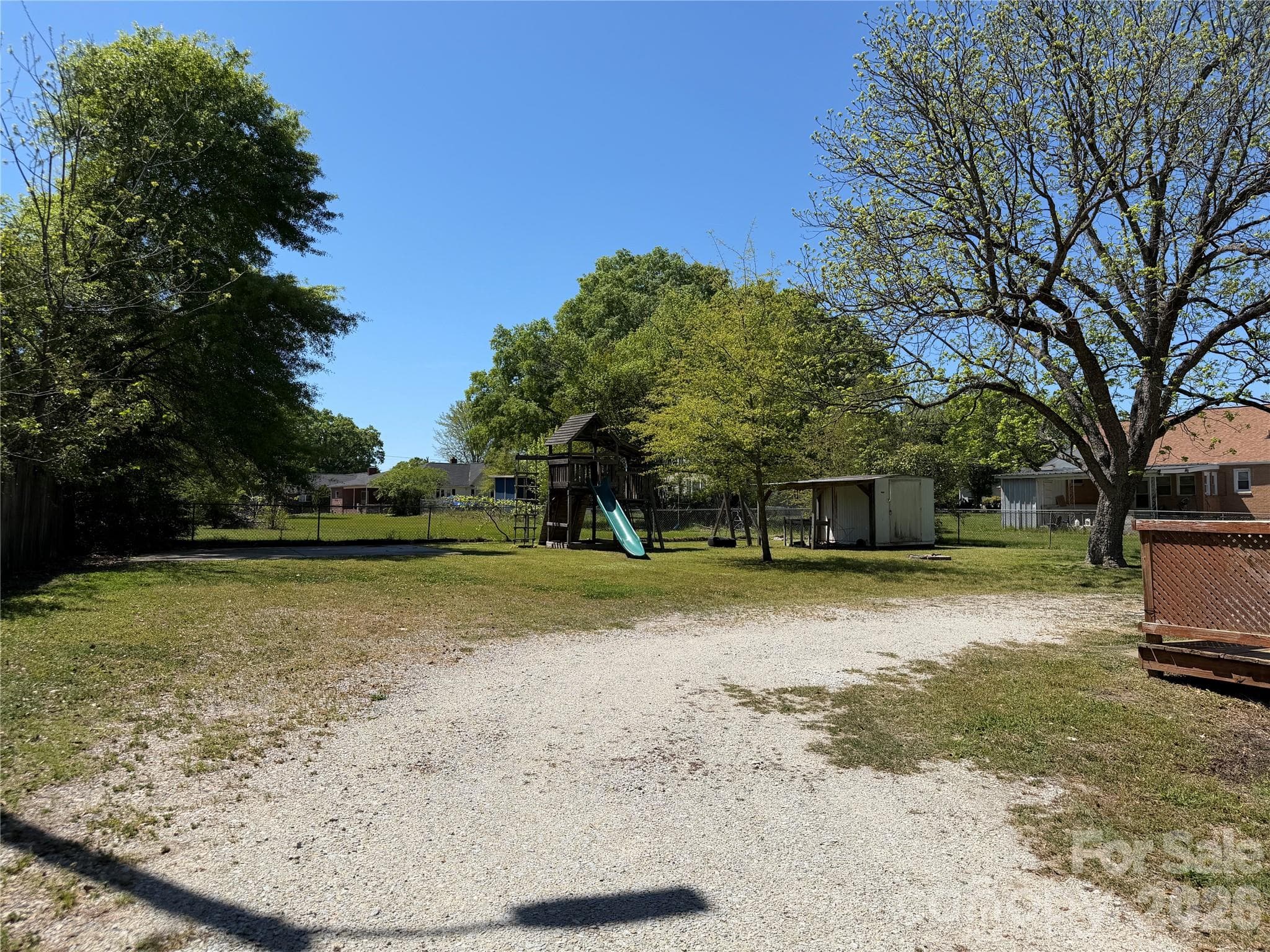 Large backyard with play set, fire pit, storage shed and approximately 20x20 concrete pad. Perfect for carport, storage shed or garage. - 612 Ballard Street, Chester