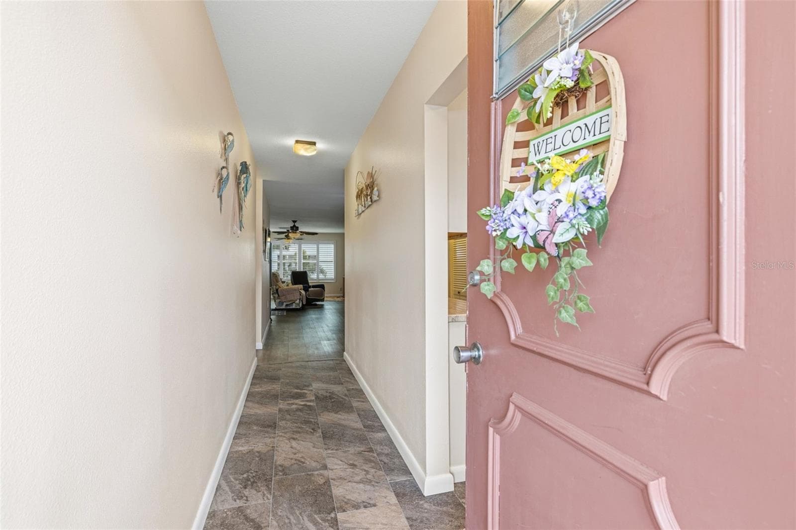 Interior entry hallway with updated flooring - 5521 80TH ST N #212, ST PETERSBURG
