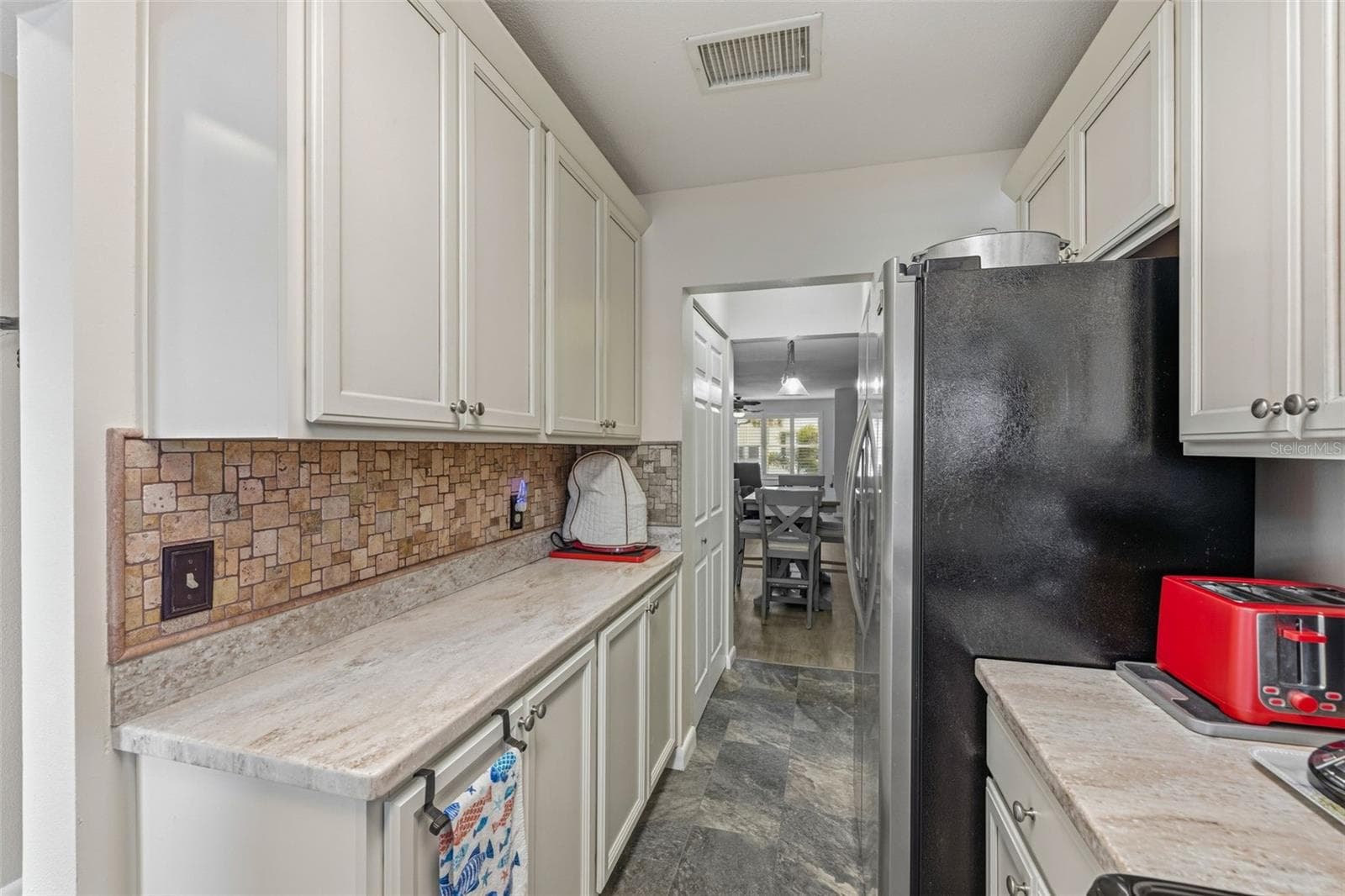 Kitchen with extended counter space and cabinetry - 5521 80TH ST N #212, ST PETERSBURG
