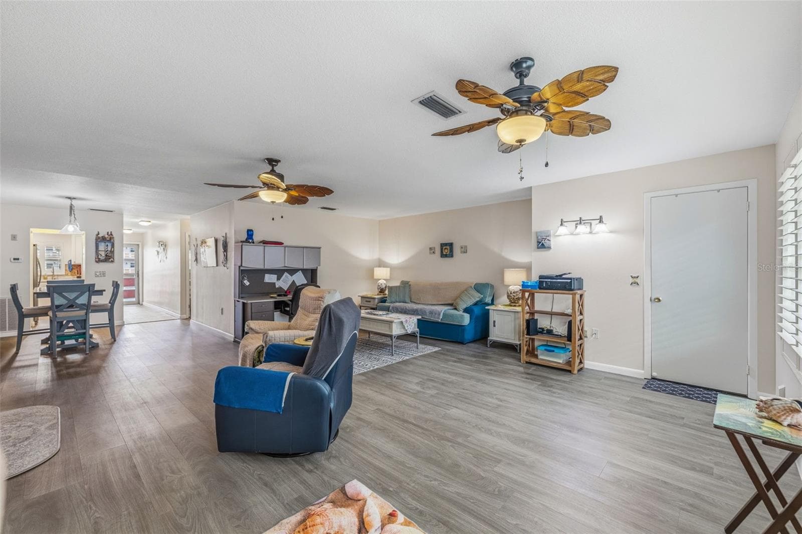 Living room with updated flooring and neutral tones - 5521 80TH ST N #212, ST PETERSBURG