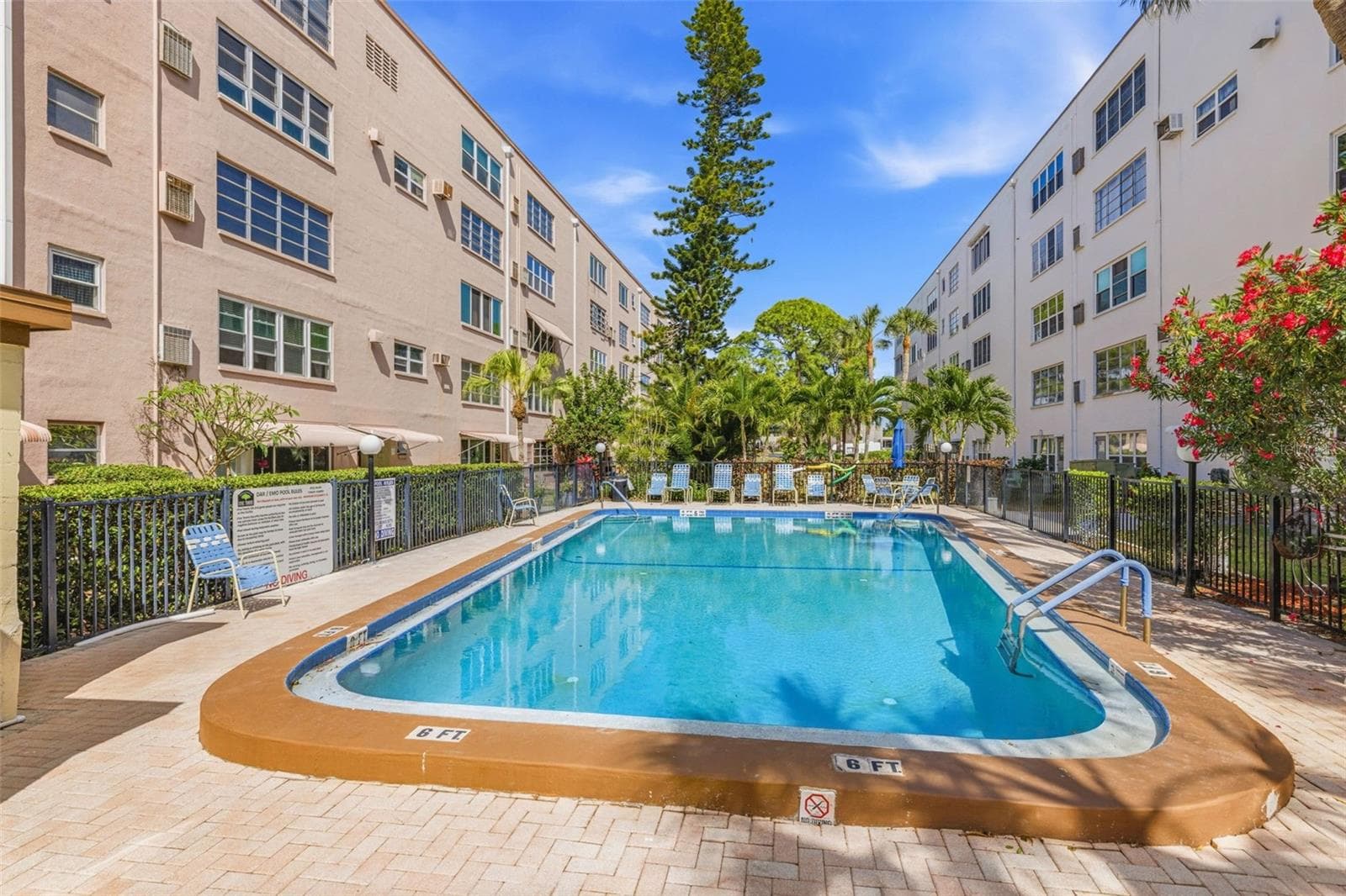 Resort style pool area with seating - 5521 80TH ST N #212, ST PETERSBURG