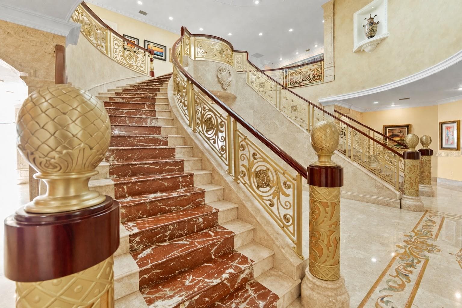 Sweeping dual marble inlaid staircases with gold and iron balustrades and ornate railings. - 2000 PARK ST N, ST PETERSBURG