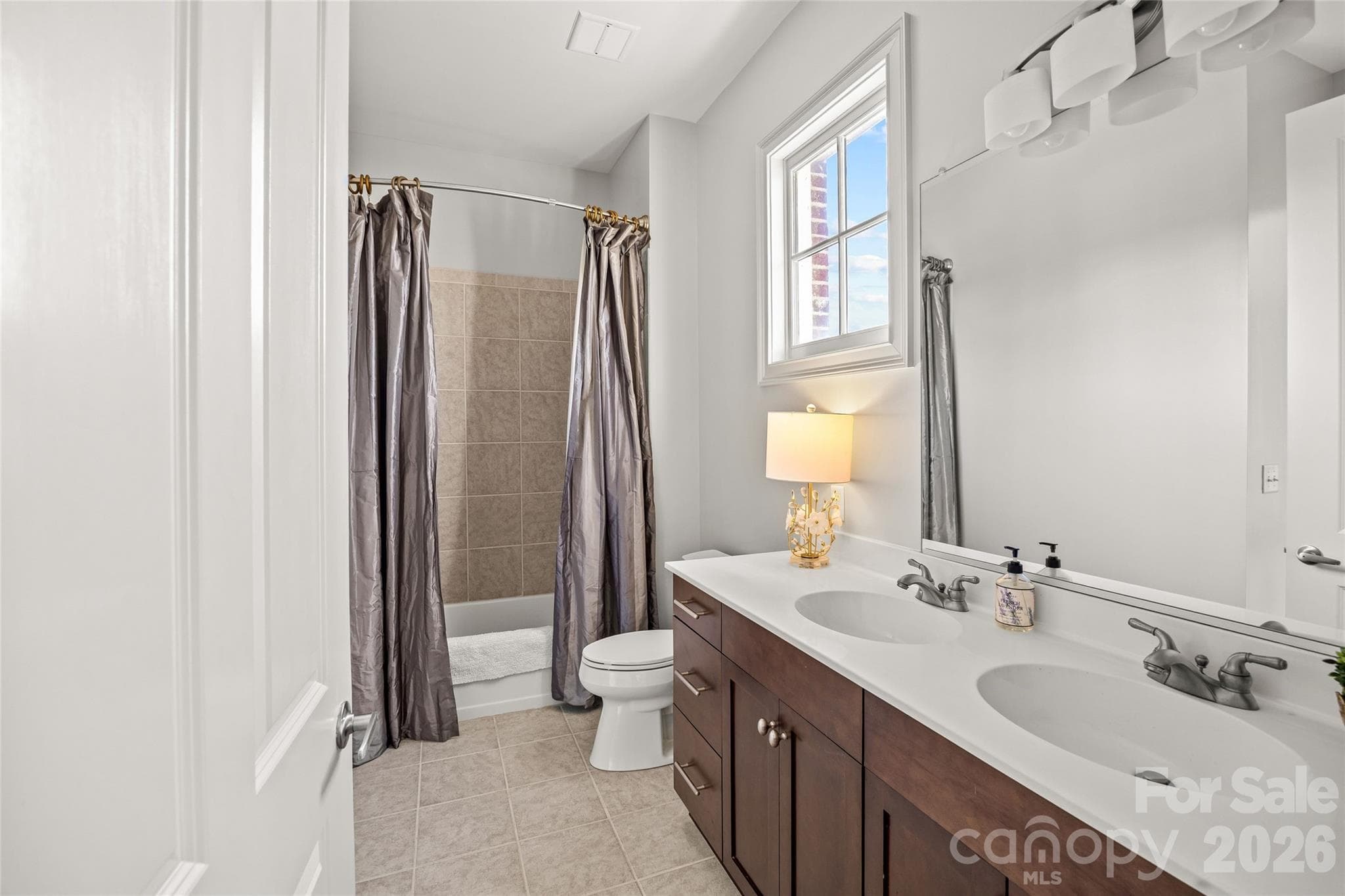 Secondary bathroom with double vanity and bathtub/shower - SouthGate on Fairview, Charlotte