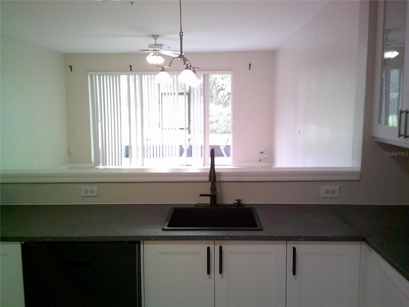 Kitchen open to Family Room / Dining Room - 6292 TWAIN ST #107, ORLANDO