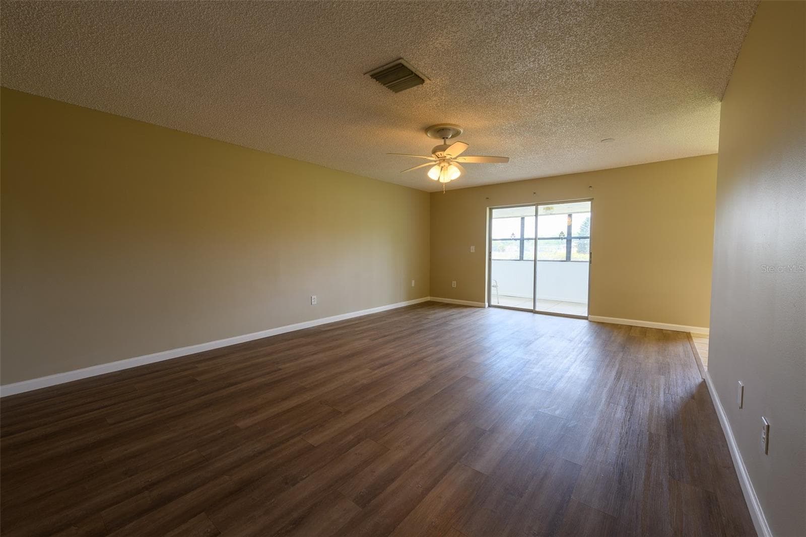 Living room leading to enclosed porch. - 1308 13TH CIR SE, LARGO