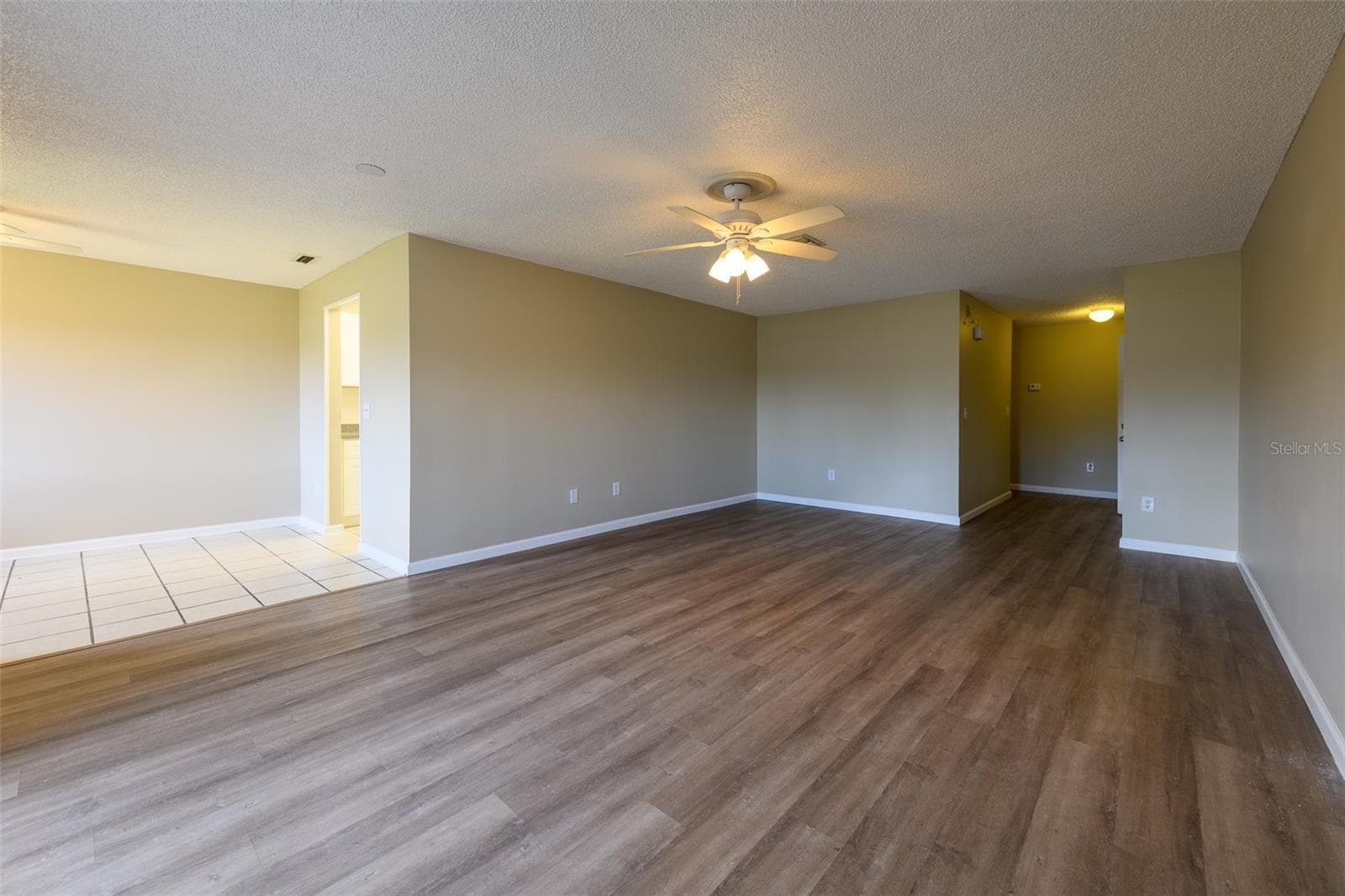 Living room view from sliding glass door, that leads to enclosed porch. - 1308 13TH CIR SE, LARGO