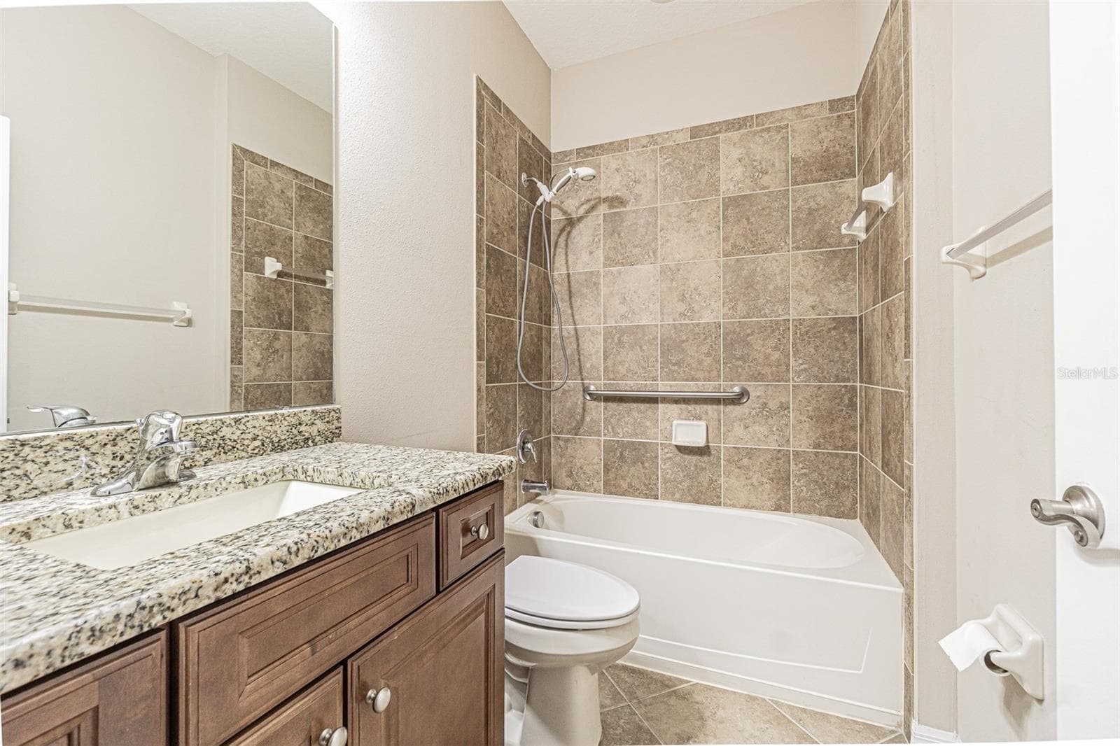 Guest bathroom with high vanity and granite. - 9936 GAP WEDGE DR, SAN ANTONIO