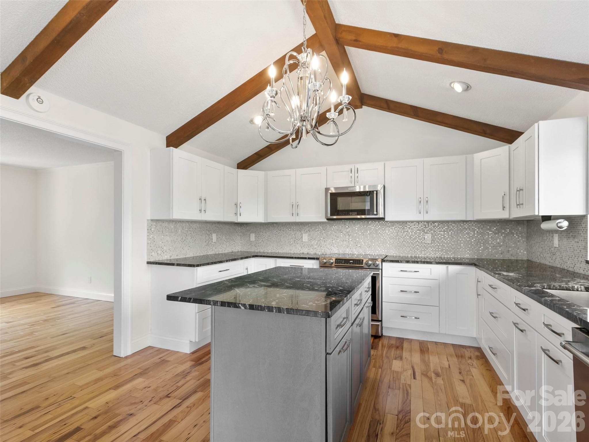 The well-appointed kitchen opens seamlessly to the dining room, creating an ideal layout for everyday living and entertaining. - 2731 Miller Lane, Hendersonville