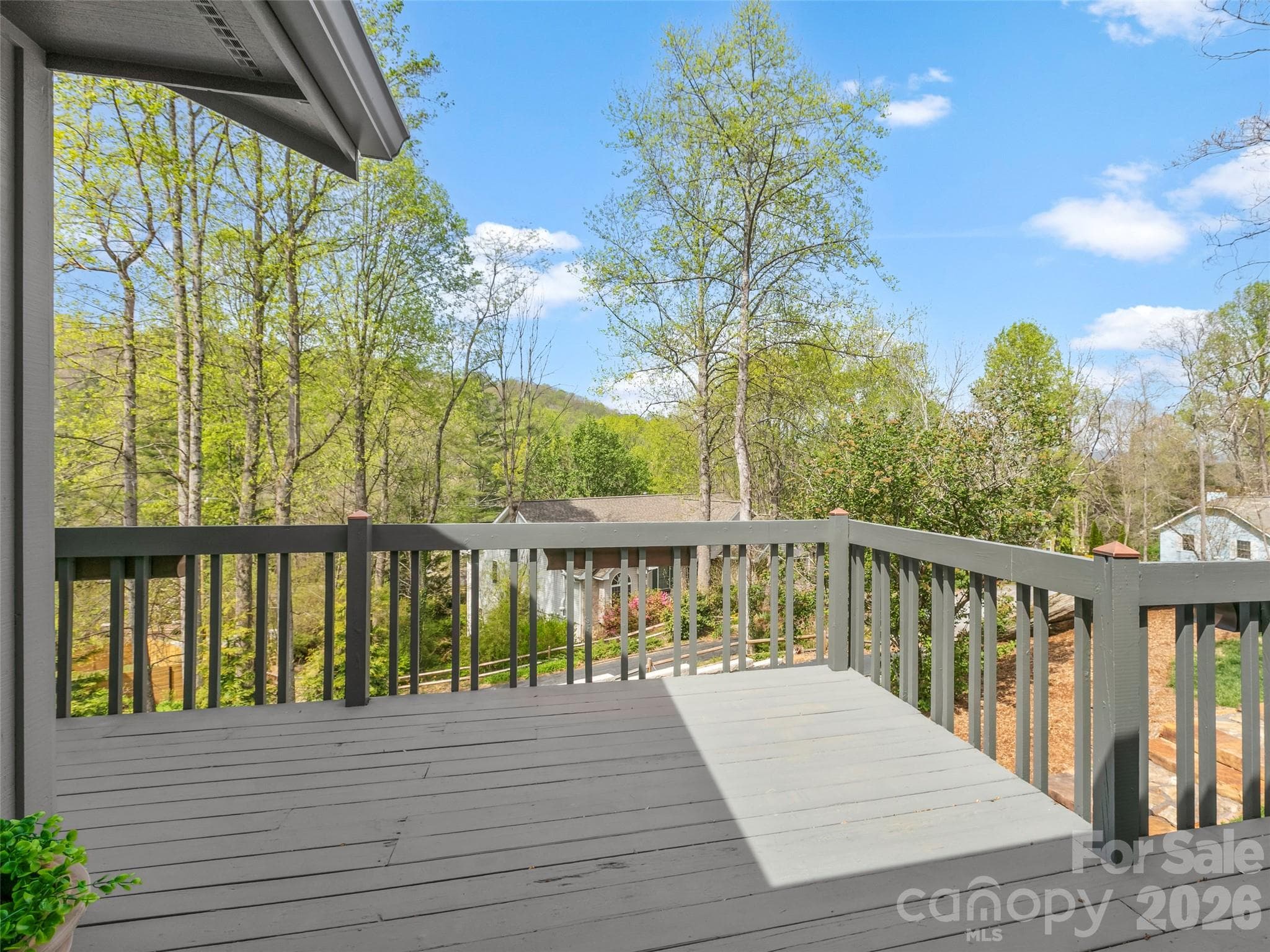 Step outside to an inviting deck where you can entertain guests or simply relax and soak in the beautiful close-range mountain views. - 2731 Miller Lane, Hendersonville