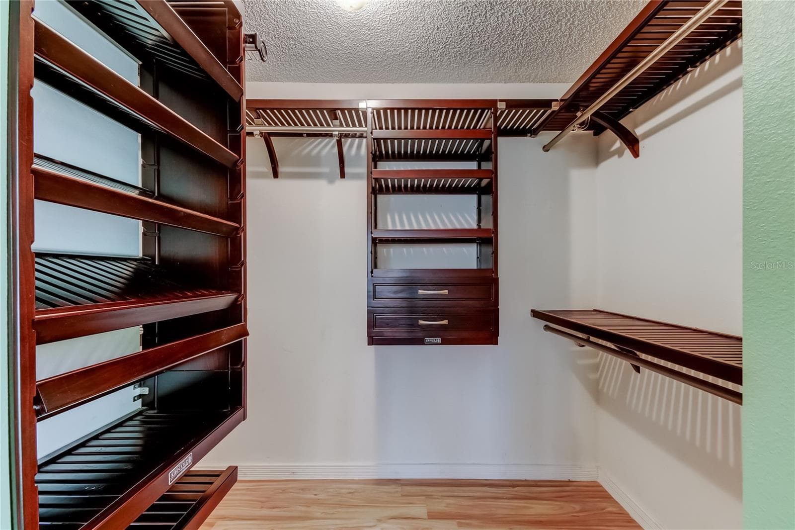 Primary Bedroom - Custom wood closet organizer - 1795 BAYHILL DR, OLDSMAR