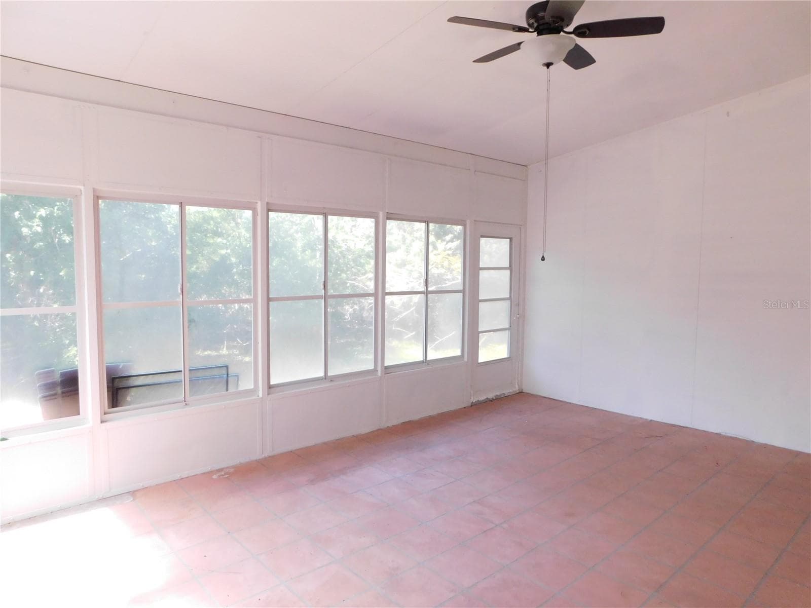 Large Enclosed Florida Room under air + celiing fan. 18x14'. Windows showcase the conservation back yard. - 1720 ARABIAN LN, PALM HARBOR