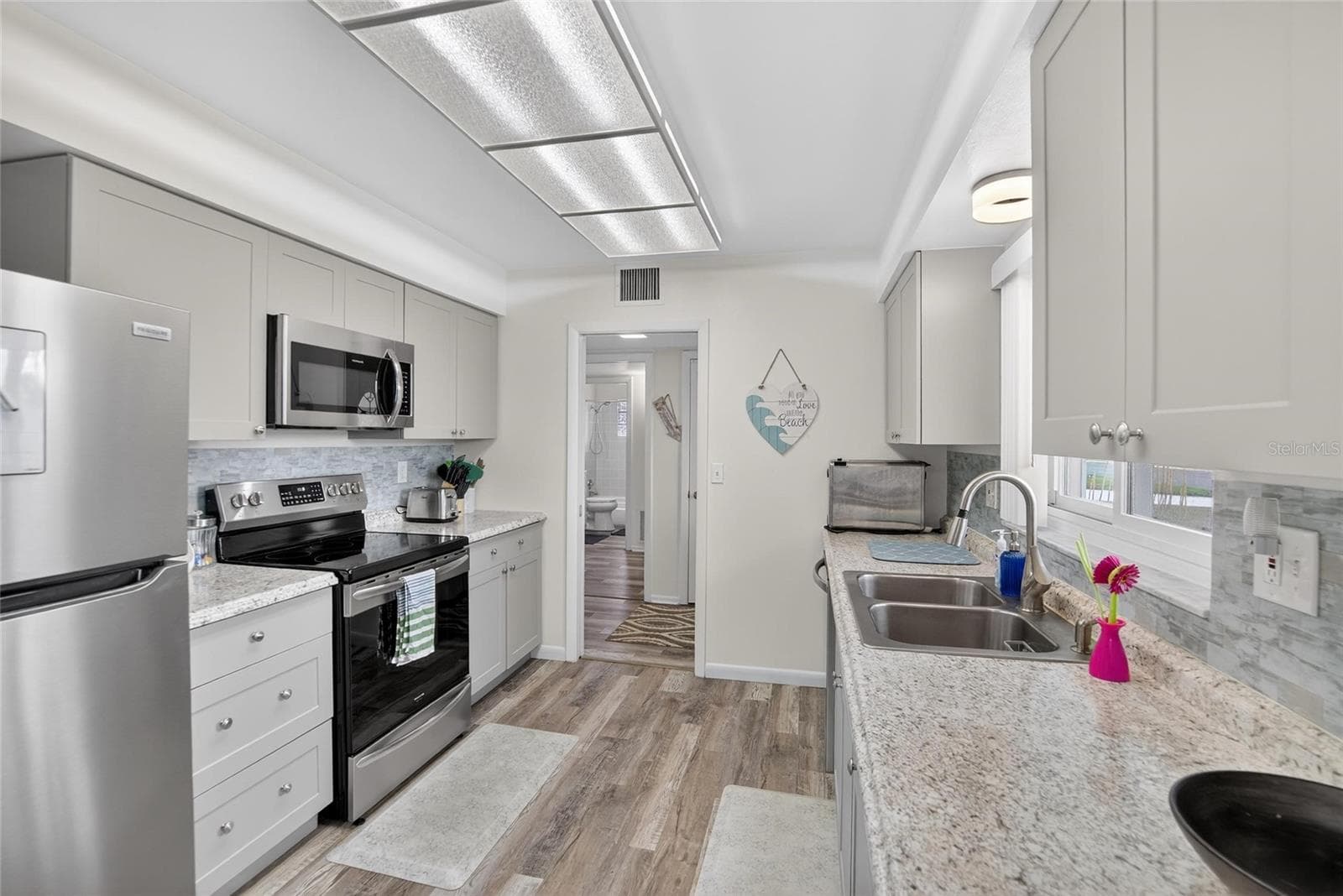 Modern, clean and bright this sparkling kitchen has lots of storage and all the features a cook could want - 809 OAKMONT AVE, SUN CITY CENTER