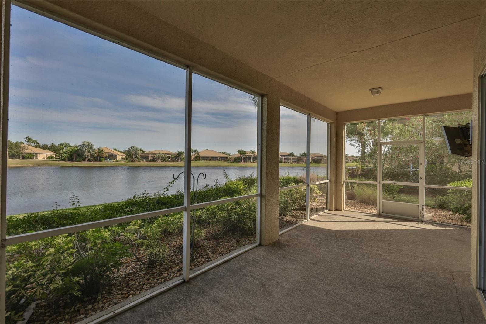 Screened Lanai with pond view looking to the east - 1324 EMERALD DUNES DR, SUN CITY CENTER