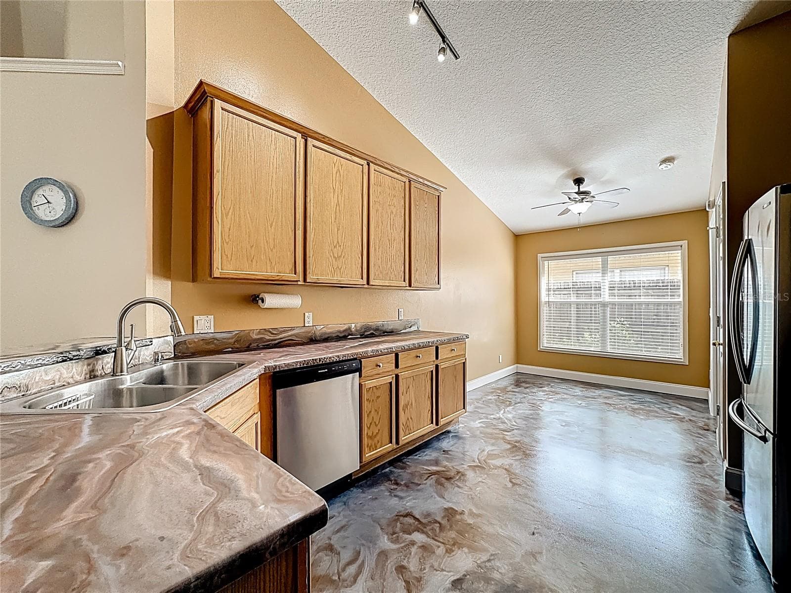 Spacious kitchen featuring expansive counter space and a stainless steel dishwasher. - 7116 COLONY POINTE DR, RIVERVIEW