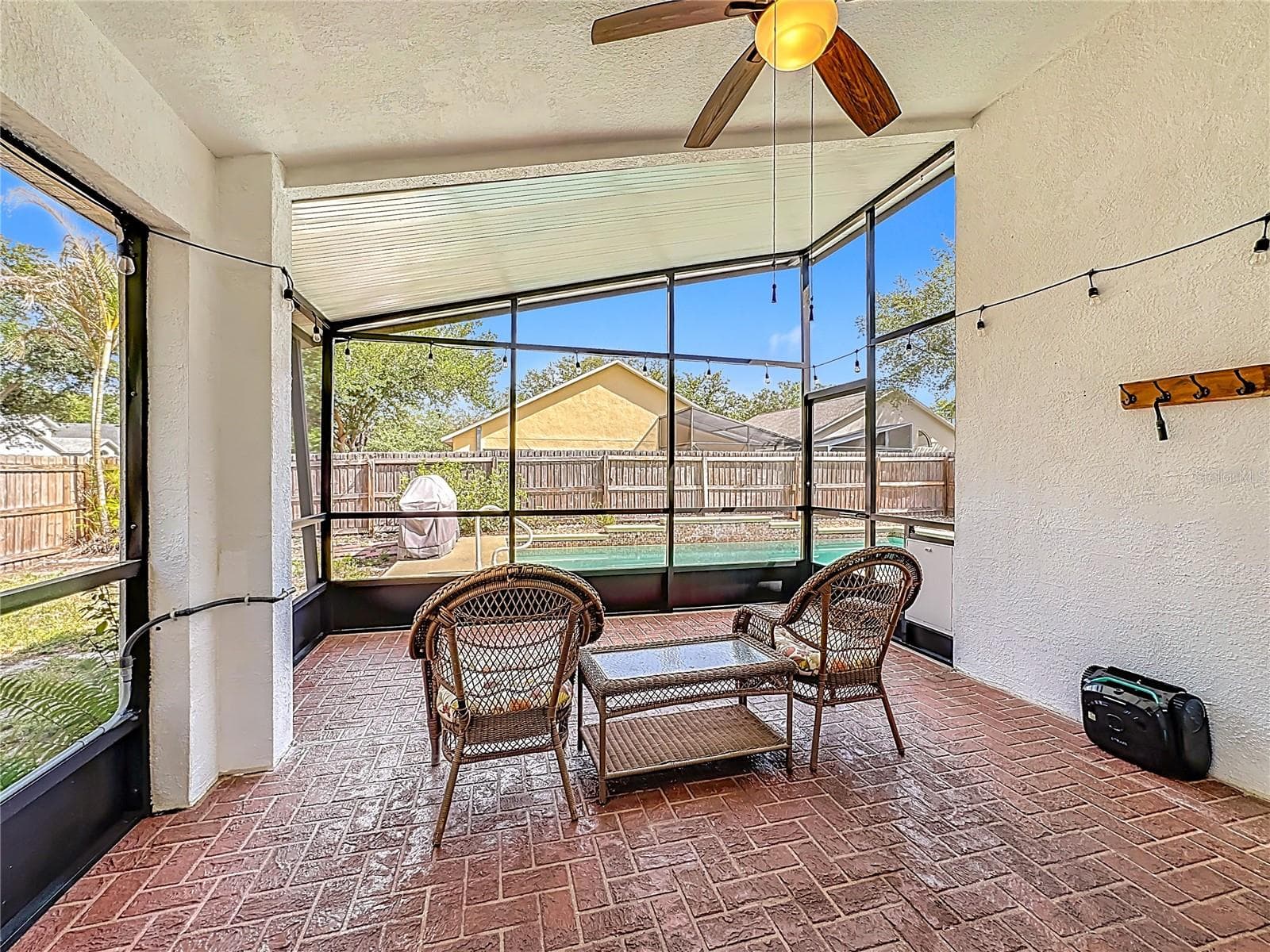 Extended, fully screened-in lanai equipped with an attached exhaust fan—perfect for outdoor dining. - 7116 COLONY POINTE DR, RIVERVIEW