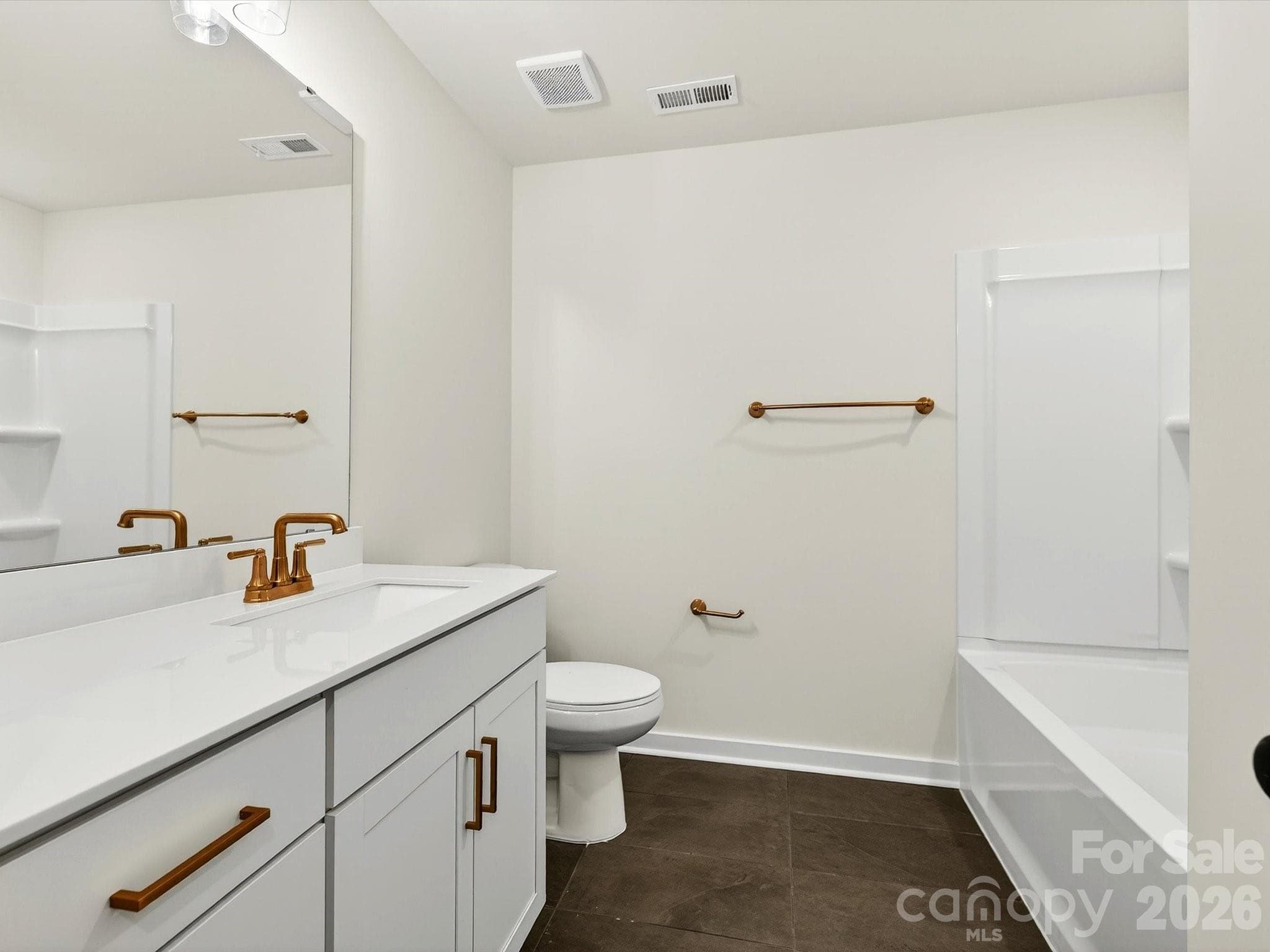 Hall bath with tiled floor, vanity with quartz countertops & linen closet - 202 Quartz Hill Way, Waxhaw