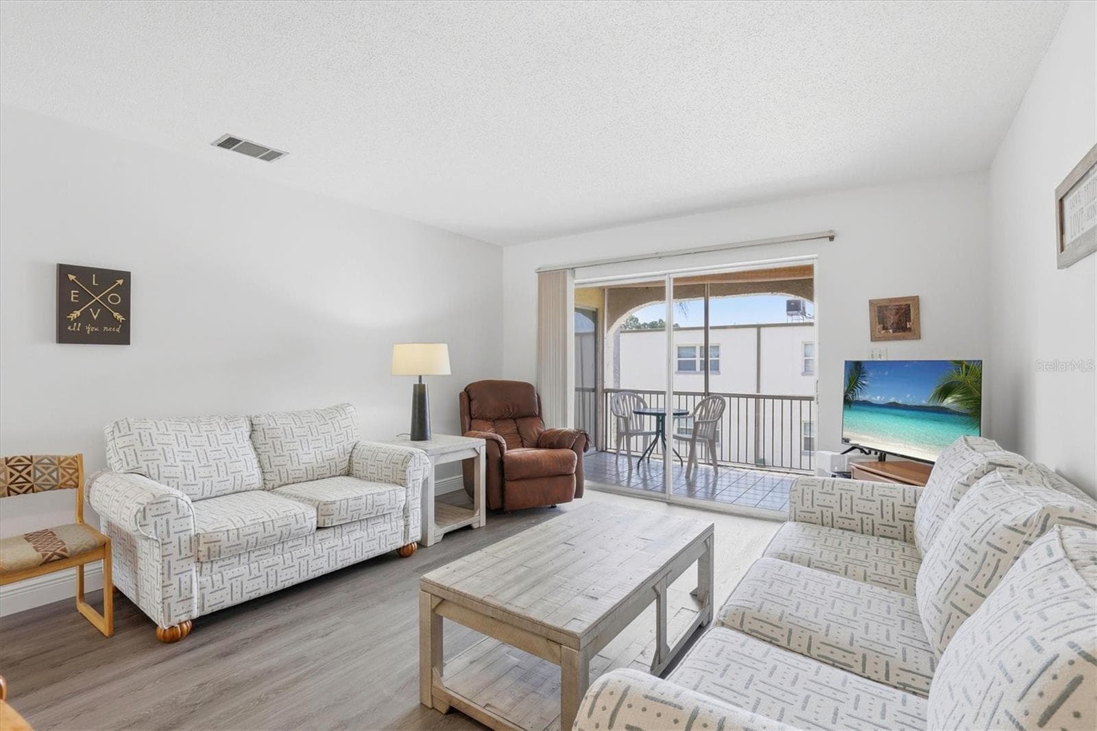 Living room over looking Balcony - 7701 STARKEY RD #412, SEMINOLE