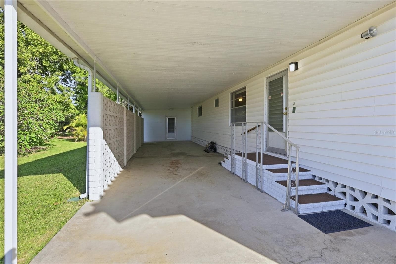Outdoor living room space under carport - 1419 41ST AVE E, ELLENTON