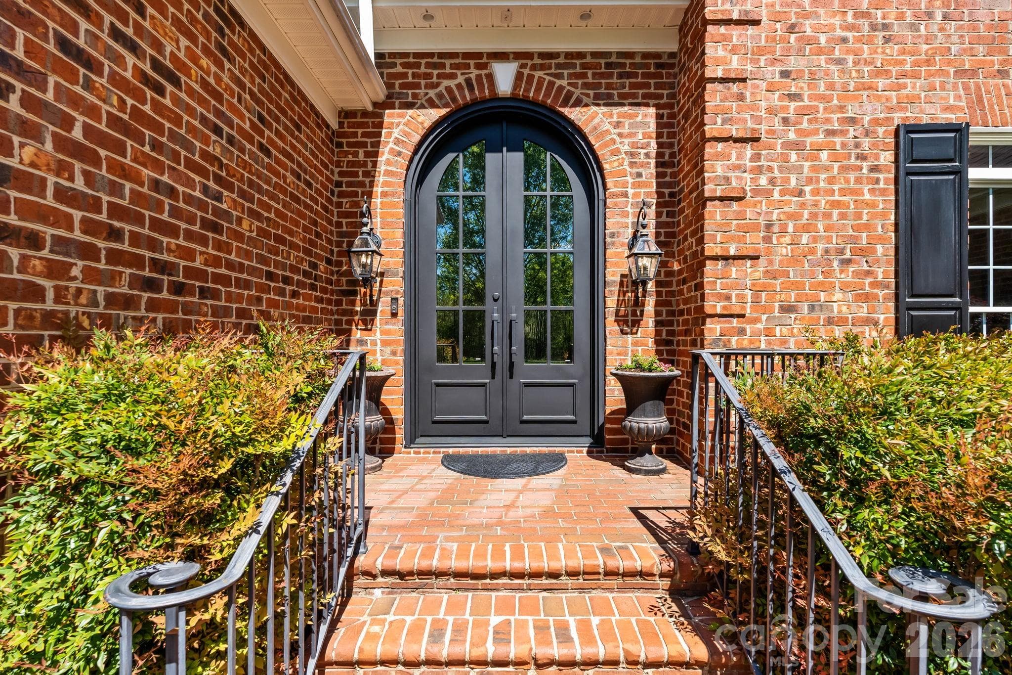 Custom made arched 10 ft steel doors welcome you in - Lewisville
