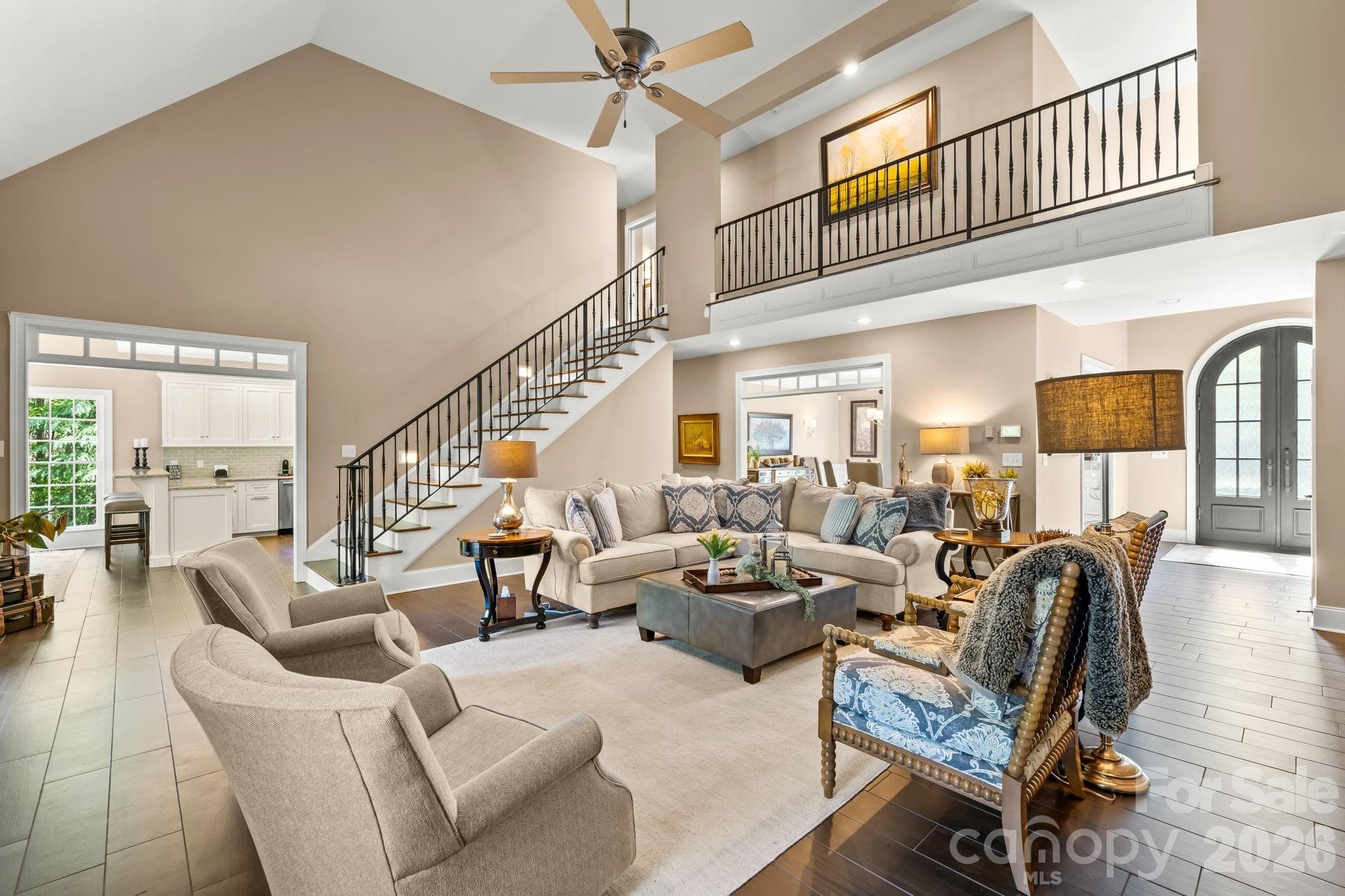 Soaring vaulted ceilings and oversized windows with a custom iron railing to the open 2nd floor balcony - Lewisville