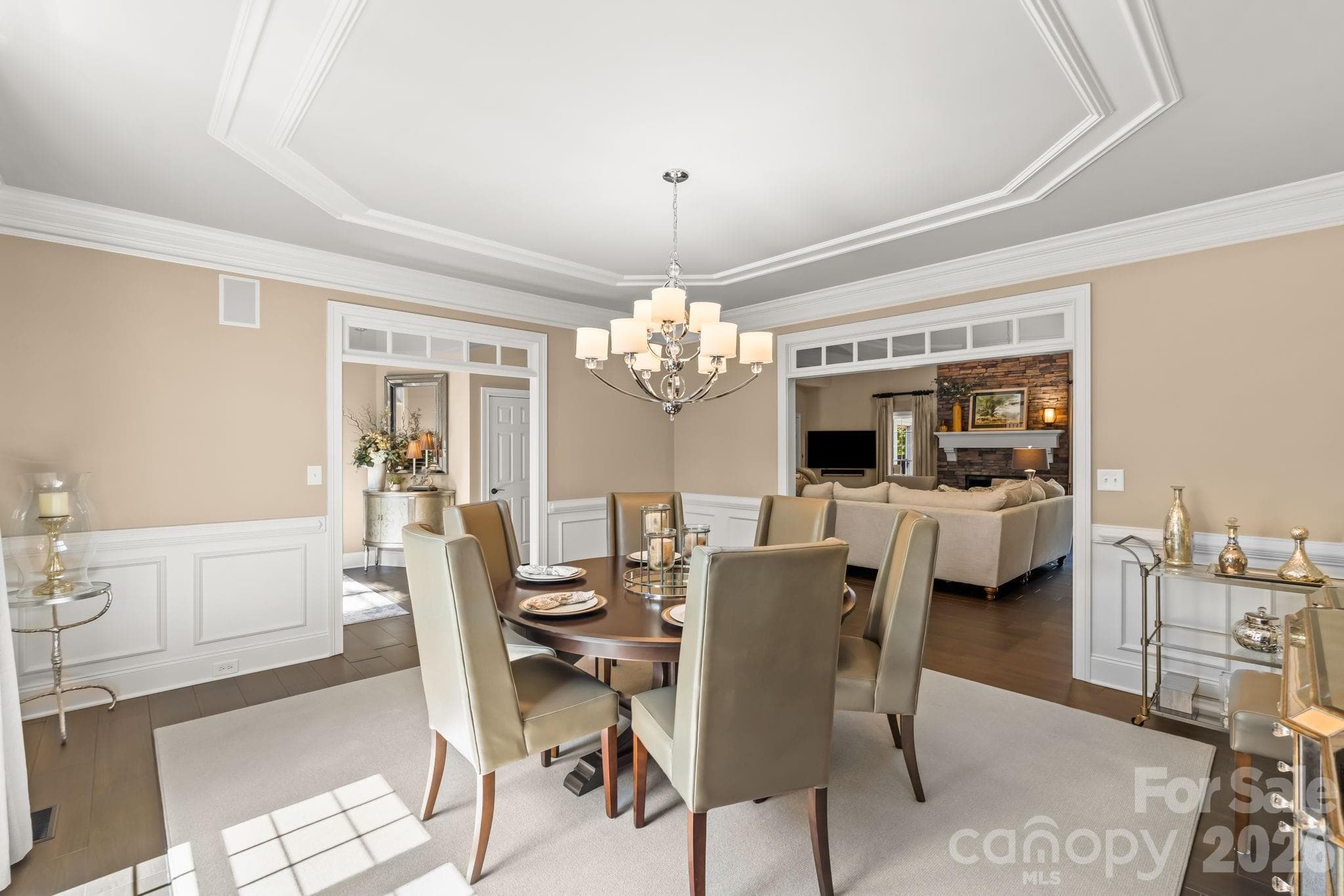 Every guest has a view when entertaining in this lovely dining room with wainscoting and oversized passthroughs - Lewisville