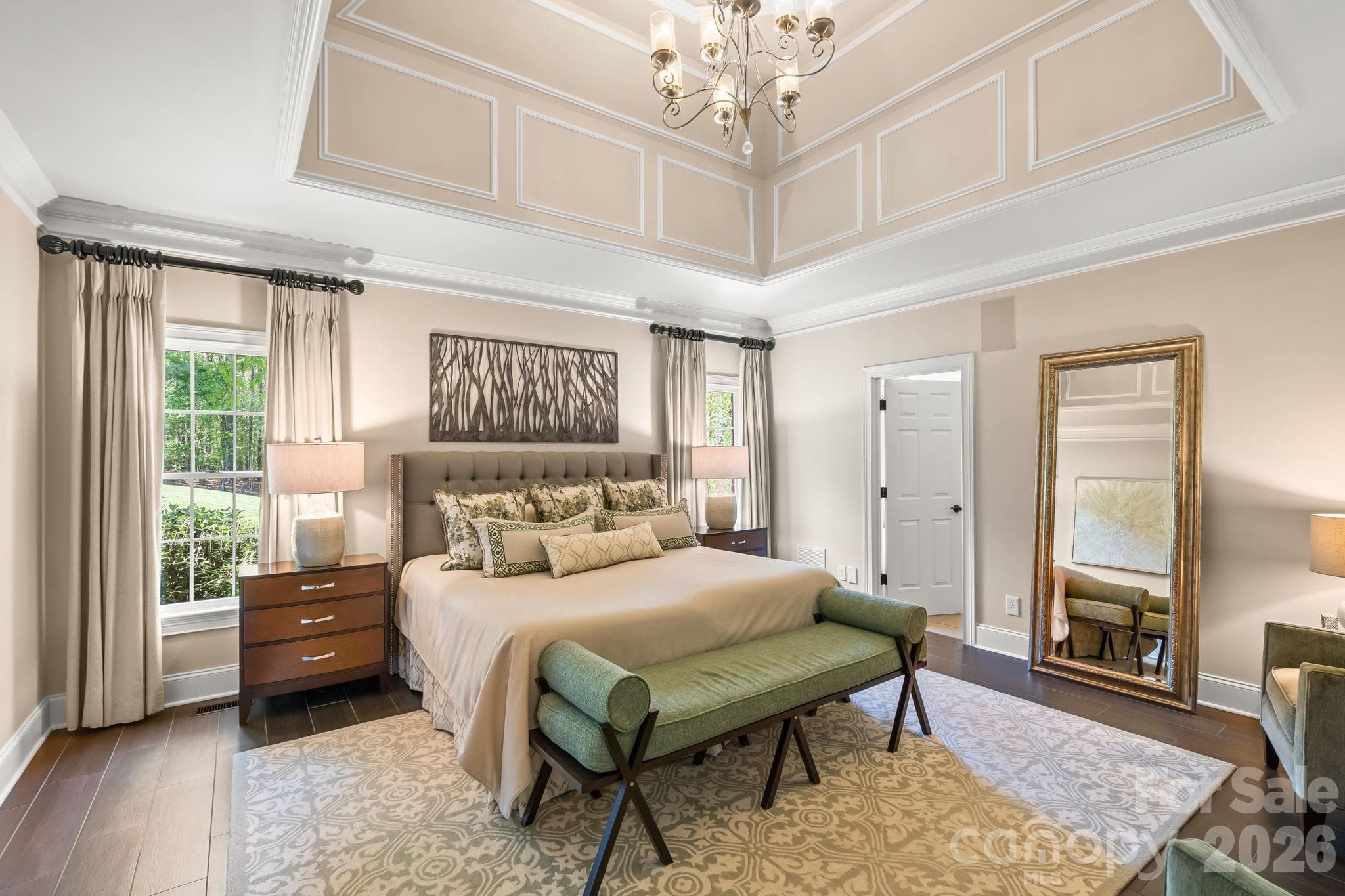 Spacious primary retreat with tray ceiling and chandelier - Lewisville