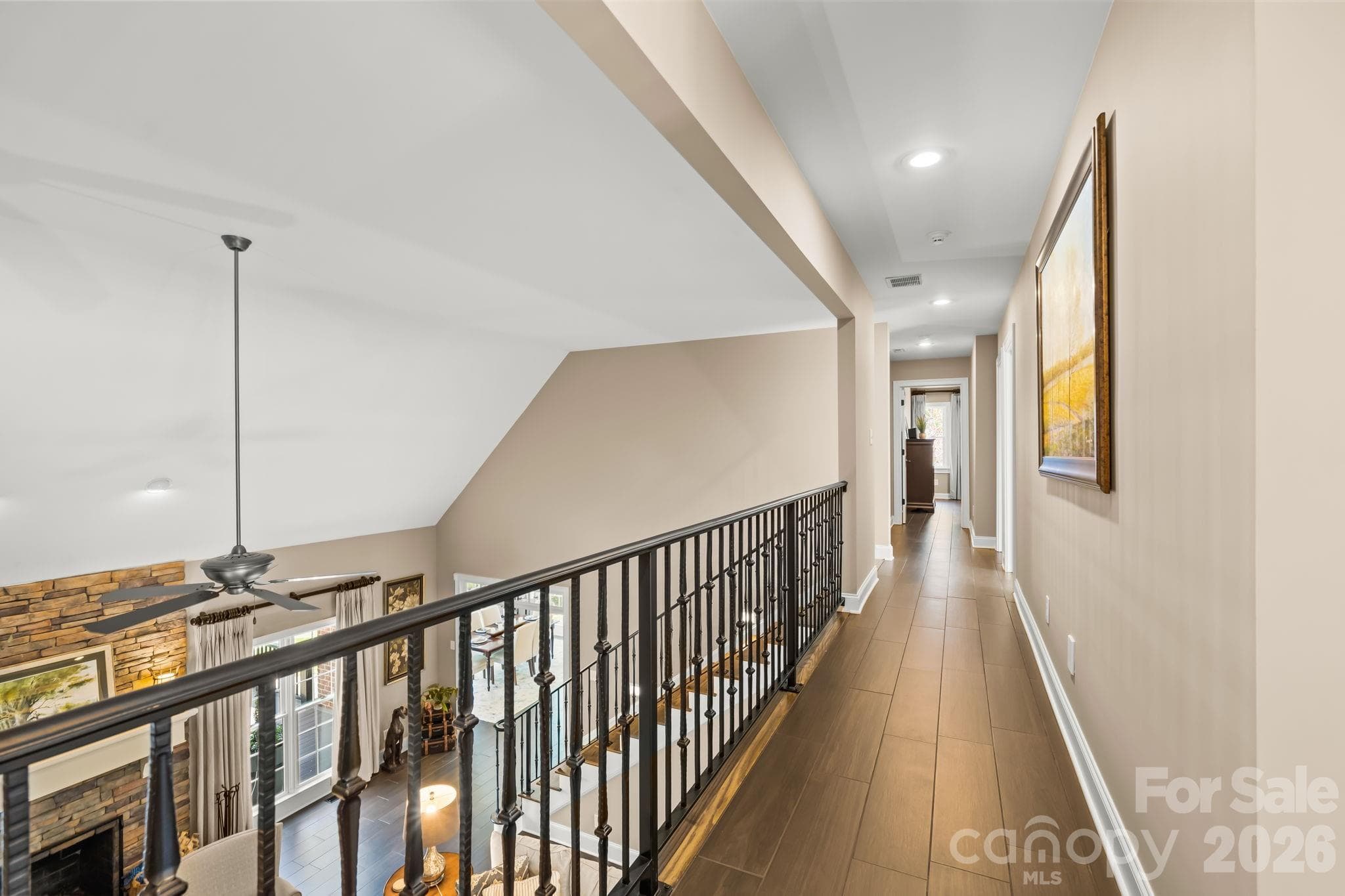 The custom iron railing is a stand out feature overlooking the great room. - Lewisville
