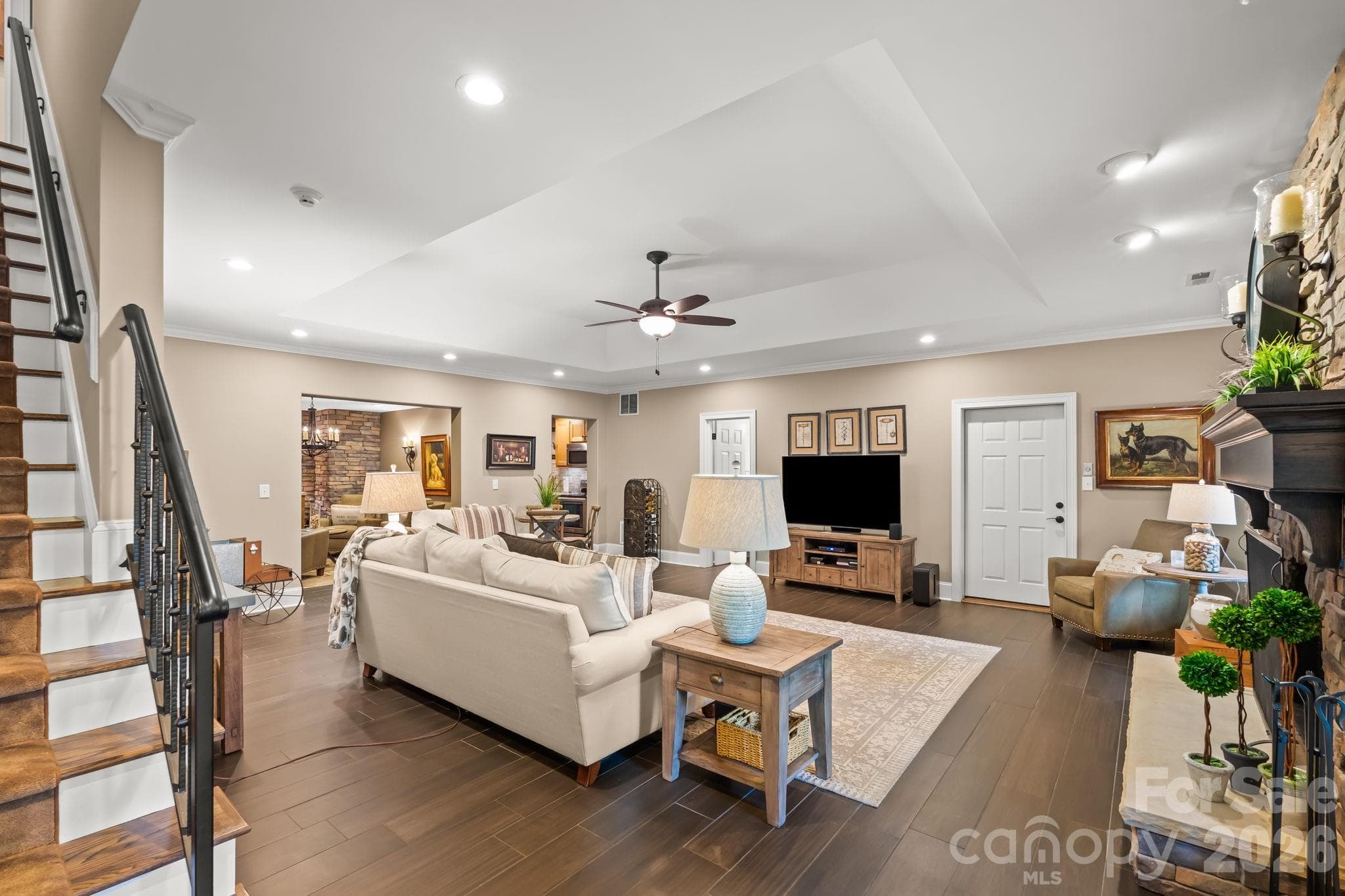 Luxurious lower level with stone fireplace, gas logs, extensive storage, kitchen, wine cellar, and garage bay. - Lewisville