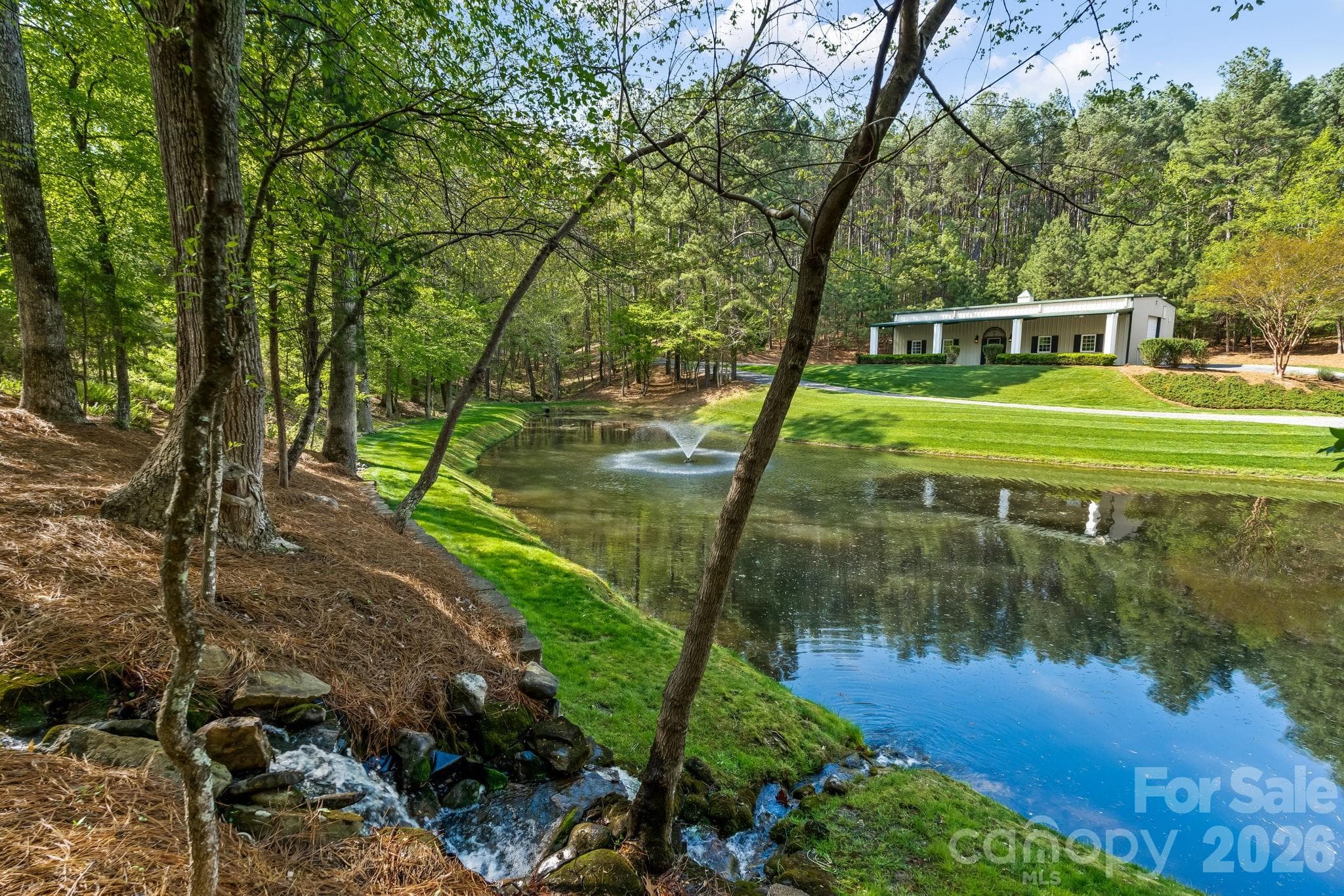 The scenic pond enhances the property and is also the source for whole property irrigation. Rainwater runoff is directed to the pond for replenishment. - Lewisville