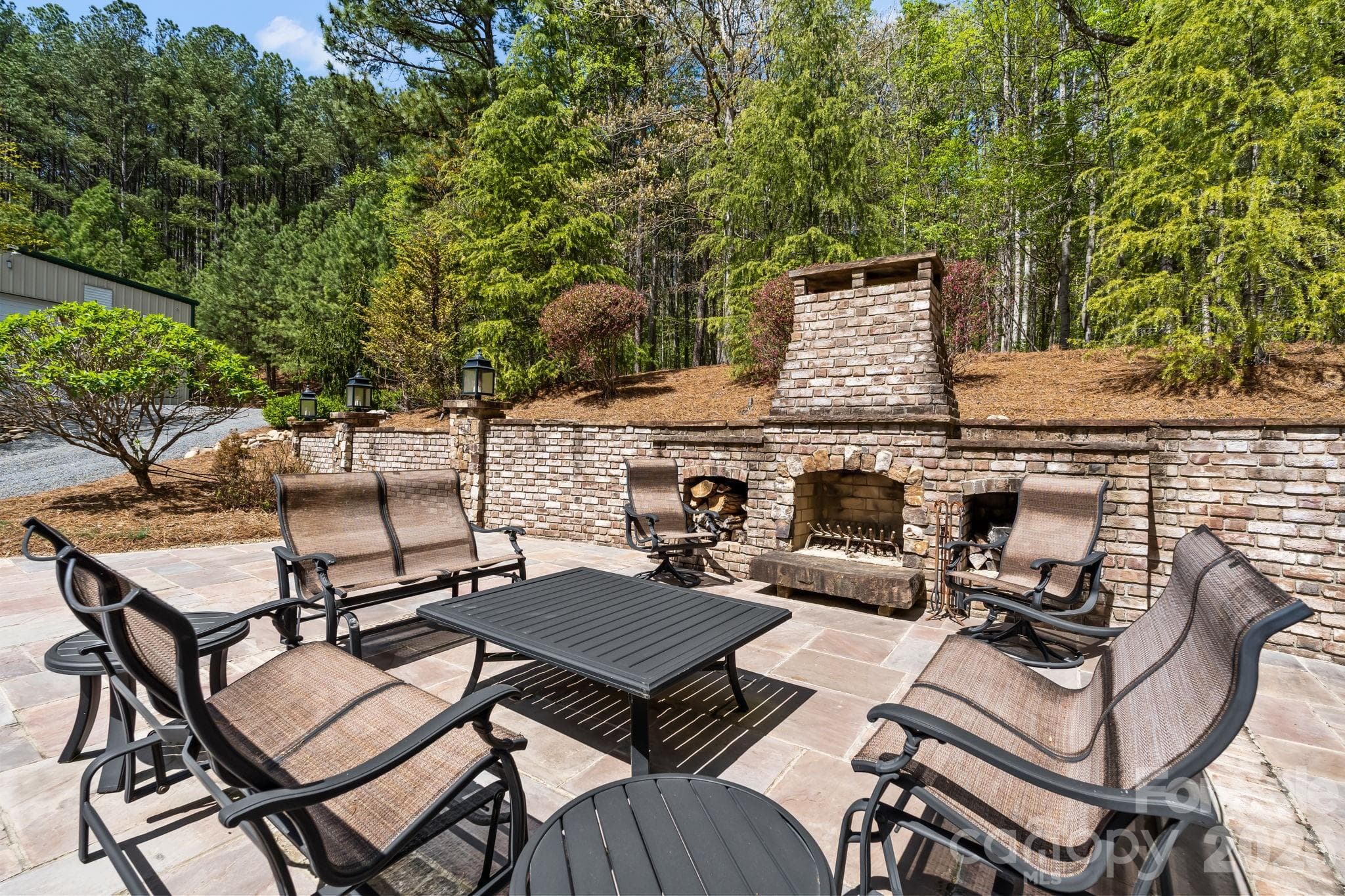 The outdoor brick fireplace and spacious bluestone patio are perfect for quiet evenings or large gatherings! - Lewisville