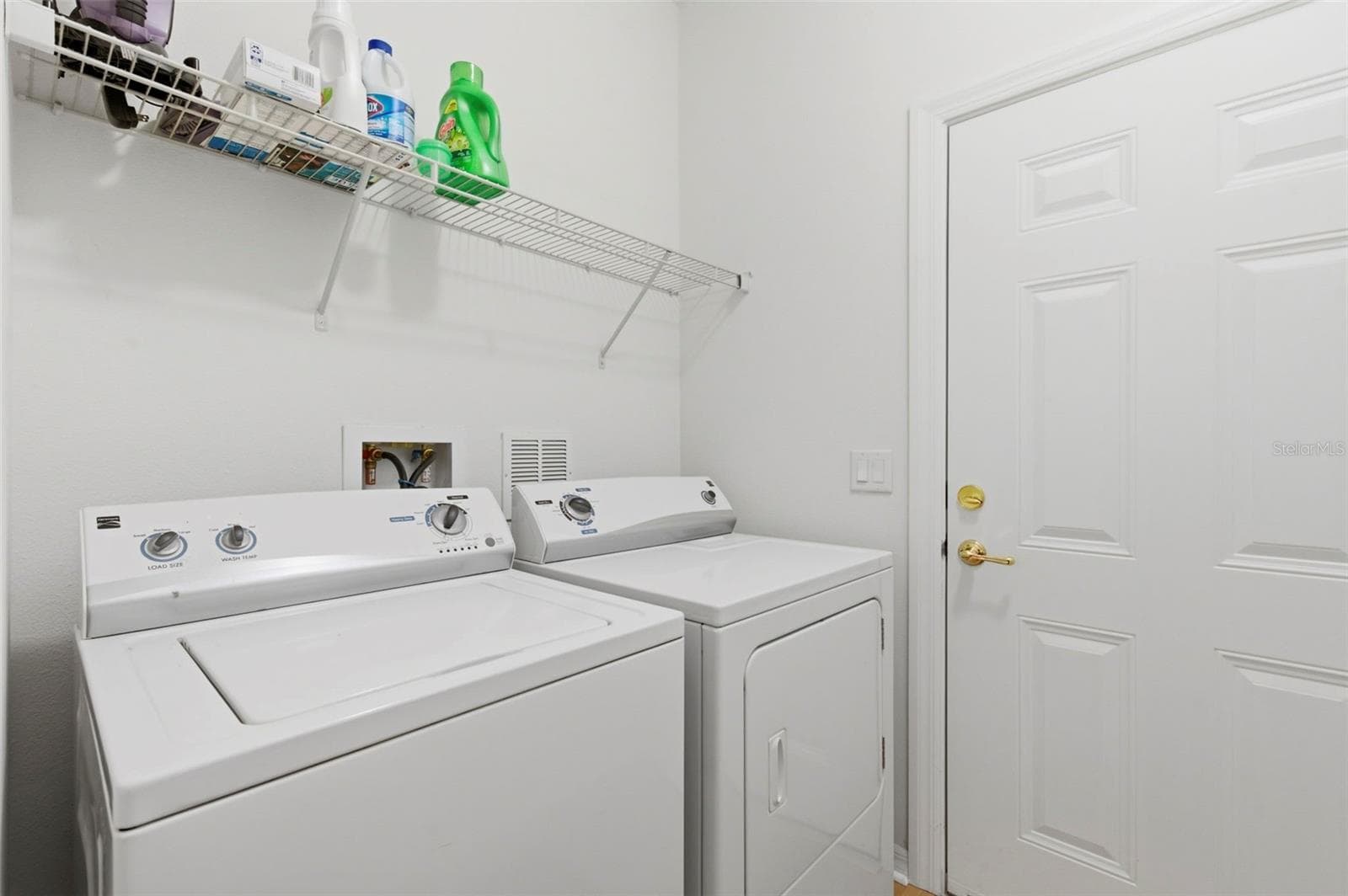 Indoor laundry room space and garage door. - 11214 PORT DOUGLAS DR, NEW PORT RICHEY
