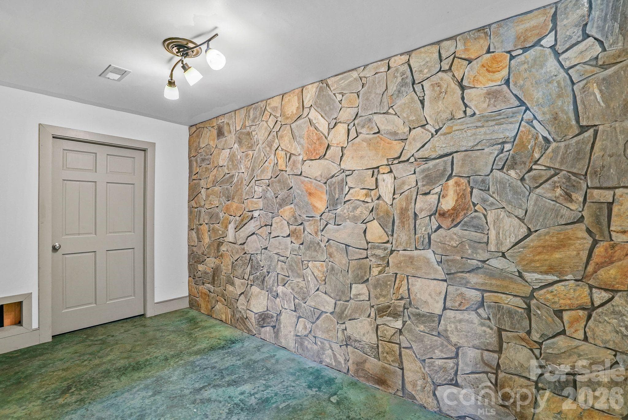 Custom stonework at bottom of basement stairs - 310 Burr Ridge, Marshall