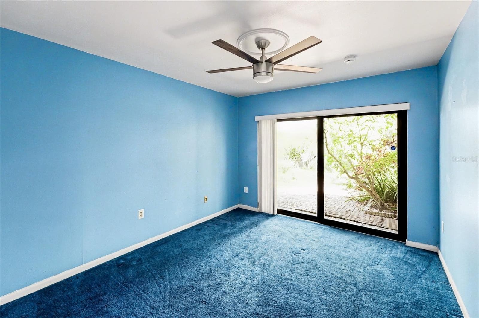 Bedroom 2 (Sliding impact resistant door to outdoor patio, Ceiling Fan) - 10755 VILLAGE CLUB CIR N #101, ST PETERSBURG