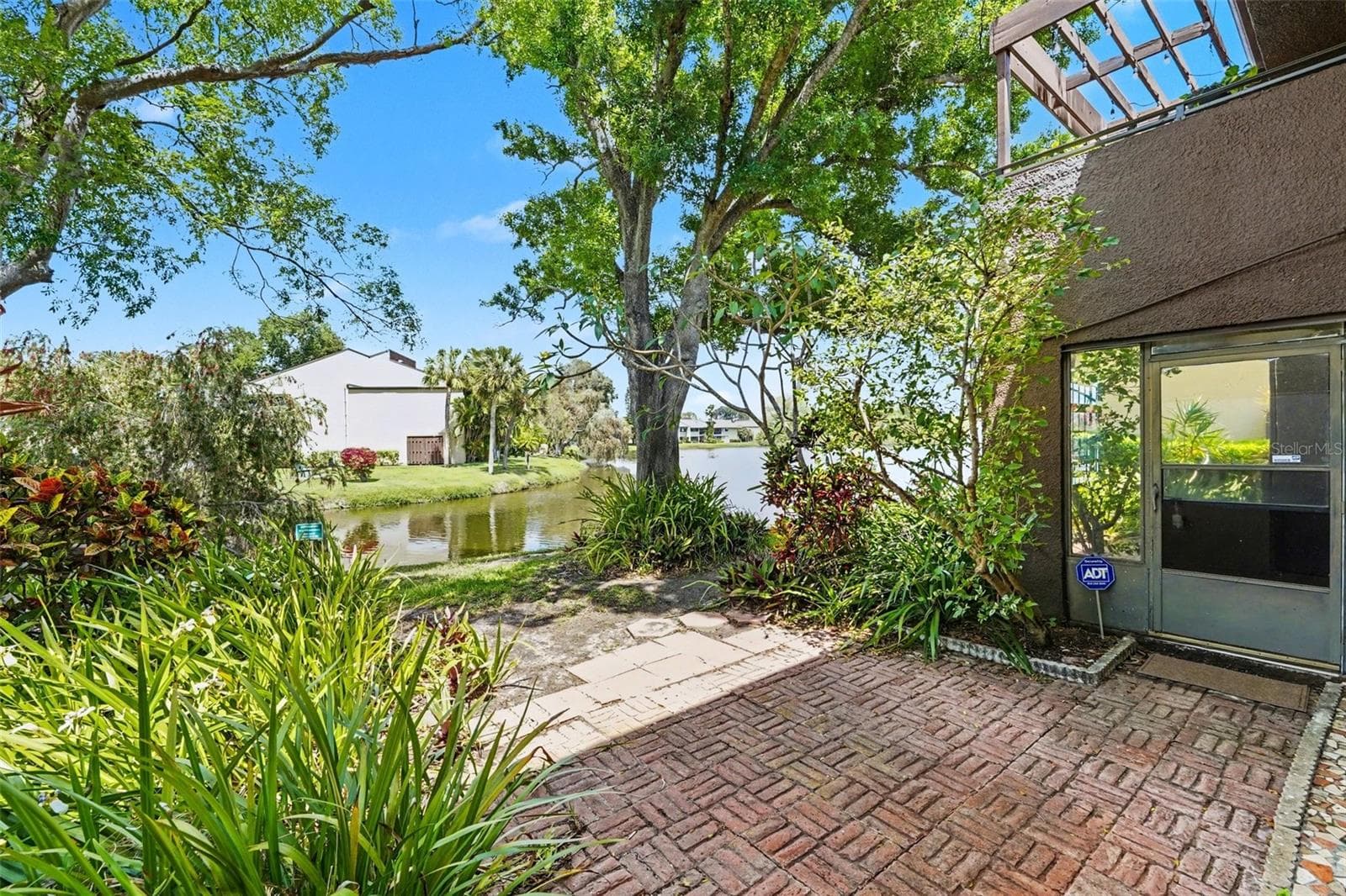 Outdoor Patio - Water View!!! (Access to enclosed patio shown here) - 10755 VILLAGE CLUB CIR N #101, ST PETERSBURG